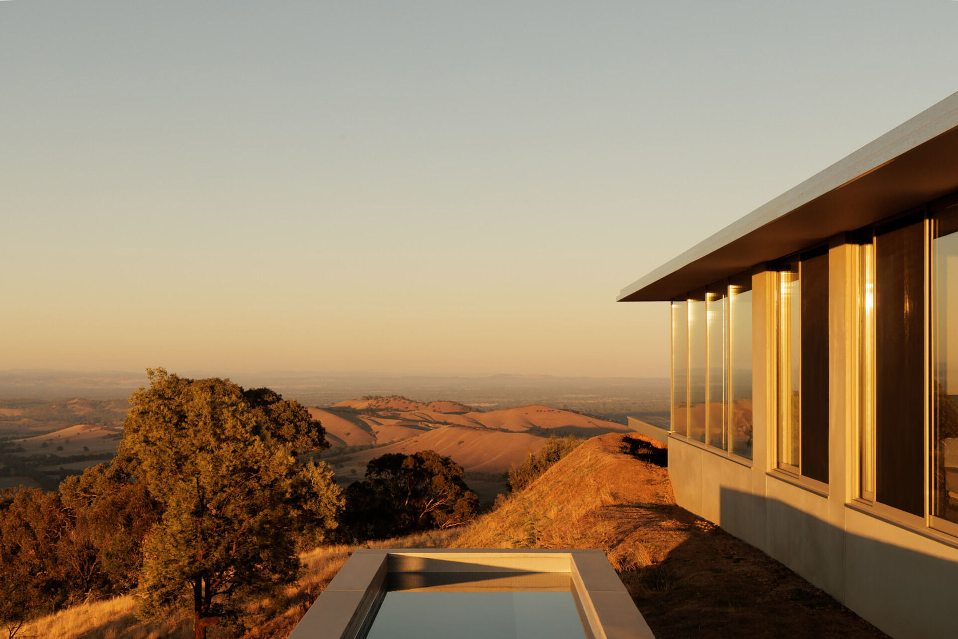 A horizon pool and spa appear to merge with the distant valleys, creating one of the most dramatic viewpoints in the entire home.