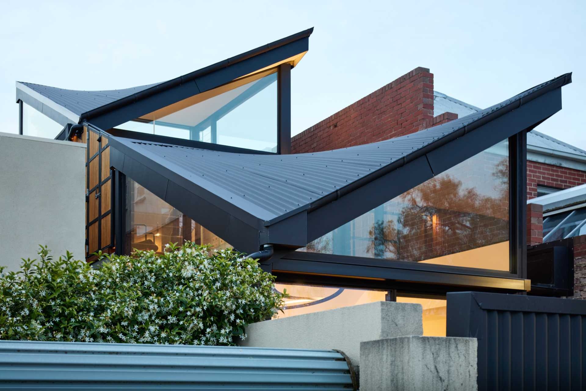 Twin parabolic roofs give this Victorian terrace extension a distinctive identity while helping natural light reach every corner of the home. See how clever roof design transformed a challenging narrow site.