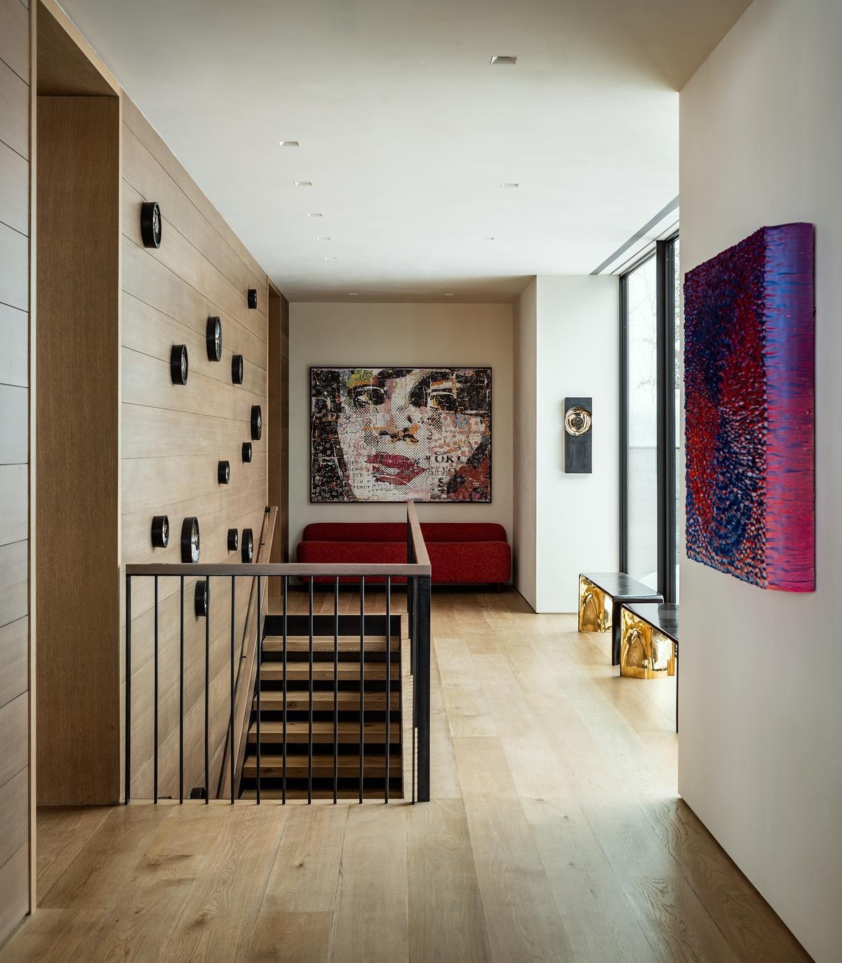 Architectural stairways and circulation spaces showcase exposed steel and timber while guiding movement through the home's split-level design and changing hillside views.