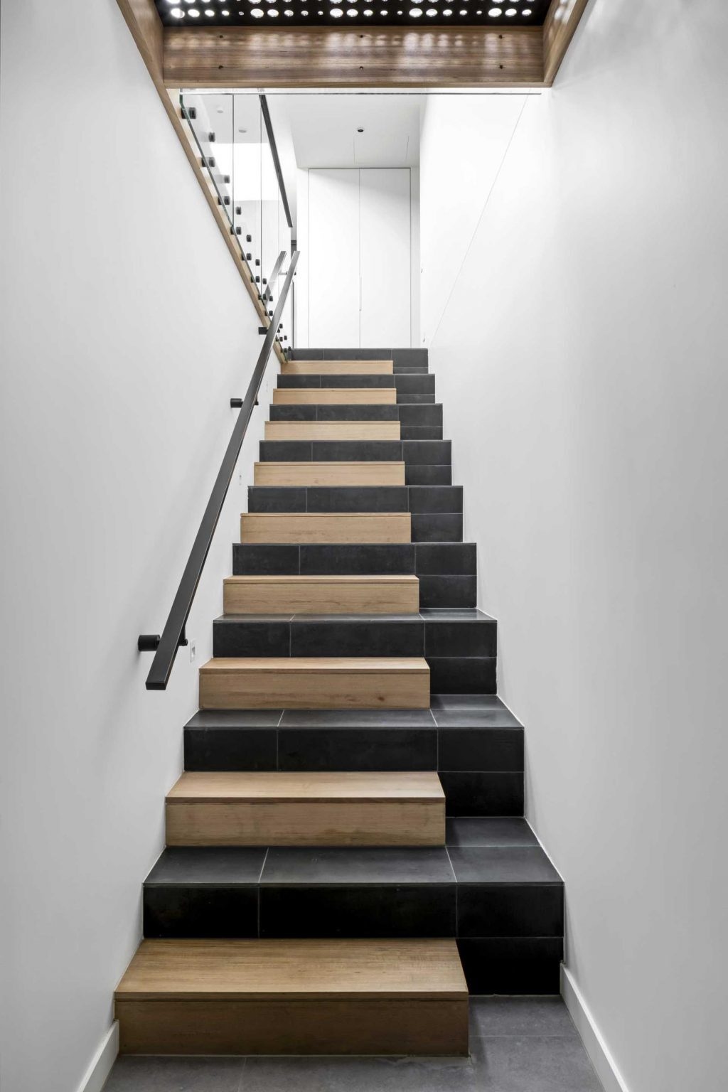 Tile and timber finishes bring texture and character to the staircase that links the home's different levels.