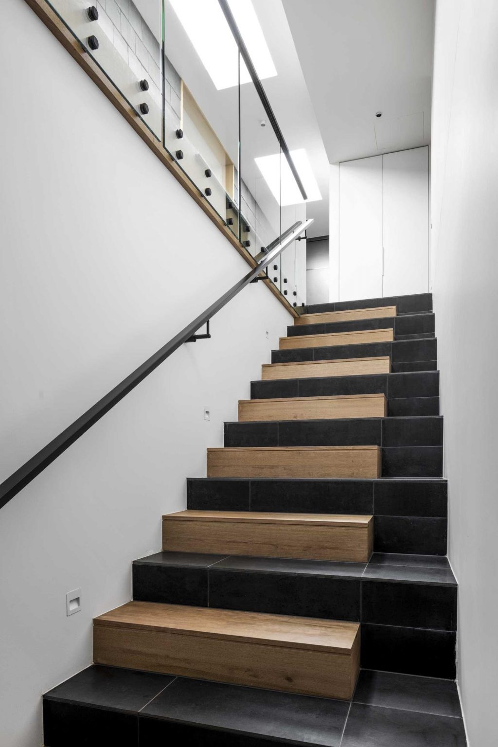 Tile and timber finishes bring texture and character to the staircase that links the home's different levels.