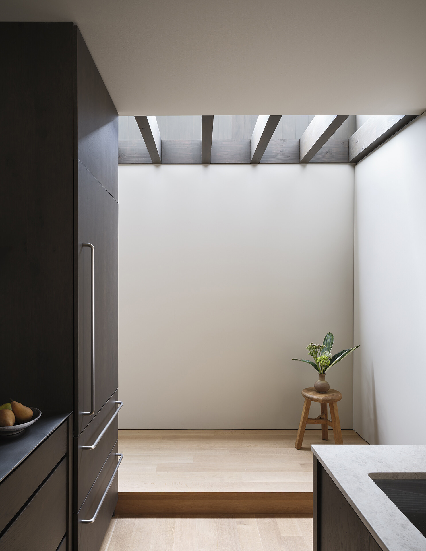 A modern staircase has natural light that shines from above.