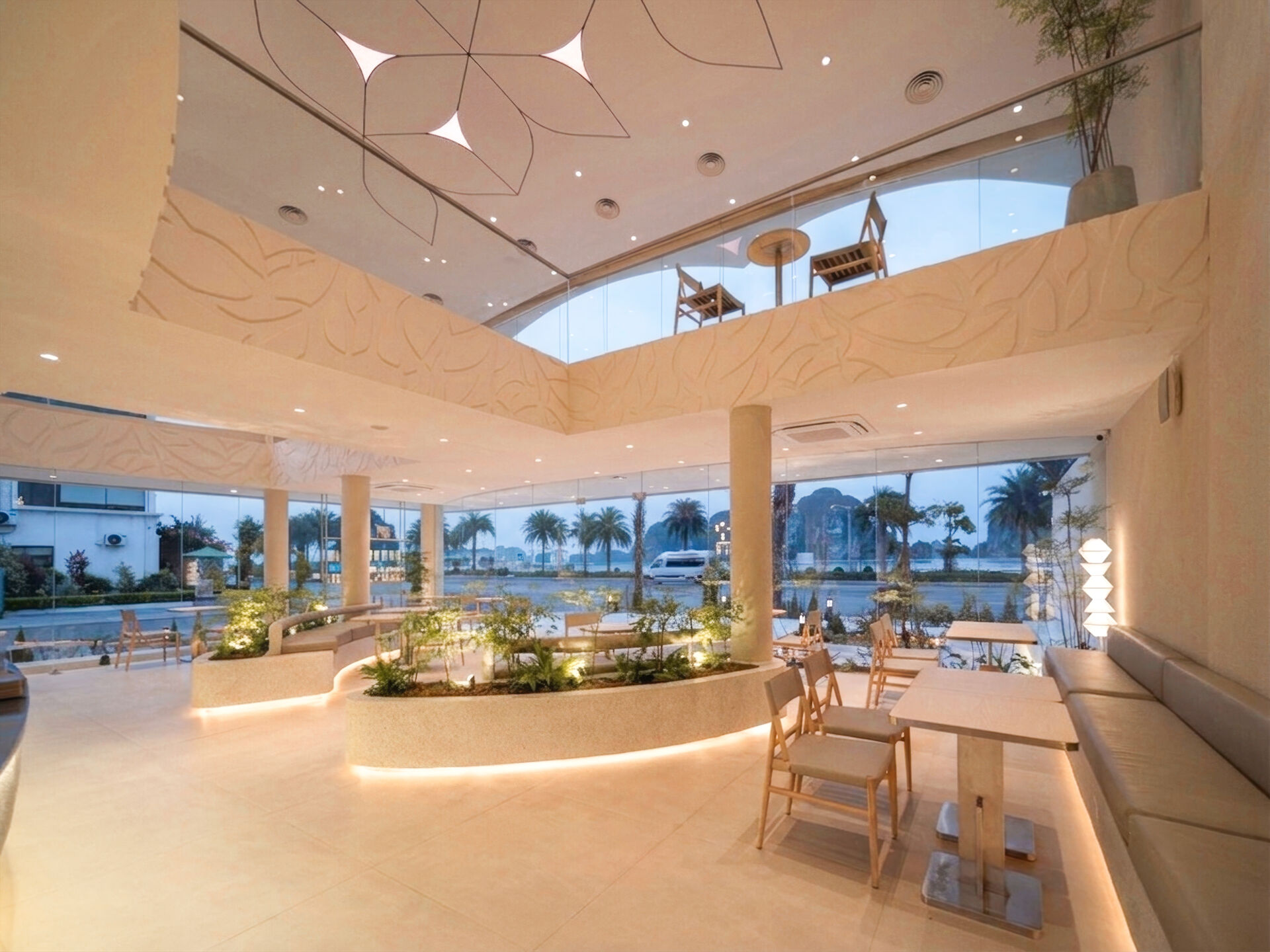 Inspired by the shape of a boat and featuring sweeping curved glass, soft flowing ceilings, and a calming neutral interior, this contemporary tea house celebrates one of Vietnam's most spectacular natural landscapes through architecture.