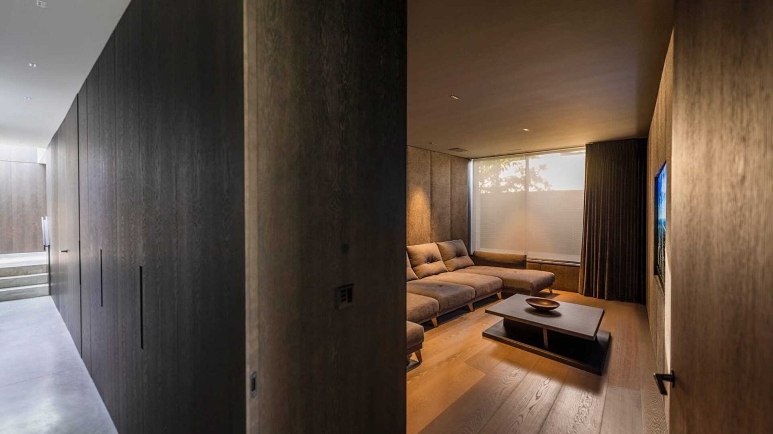 Dark stained oak appears throughout this home, creating a warm contrast to concrete, steel, and stone finishes.
