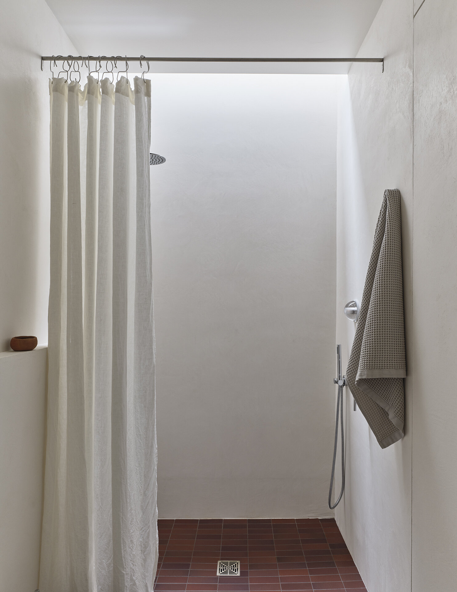 A skylight above the shower transforms this bathroom with bright natural light from above.