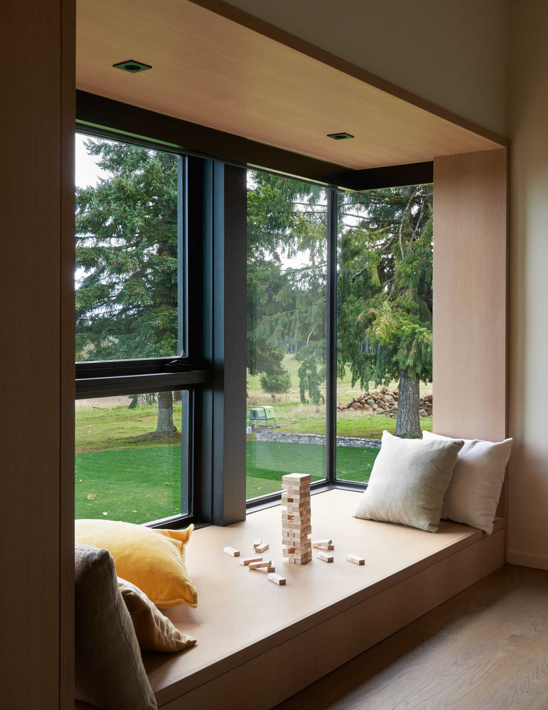 A modern built-in window seat that's large enough to act as a day bed or play area.