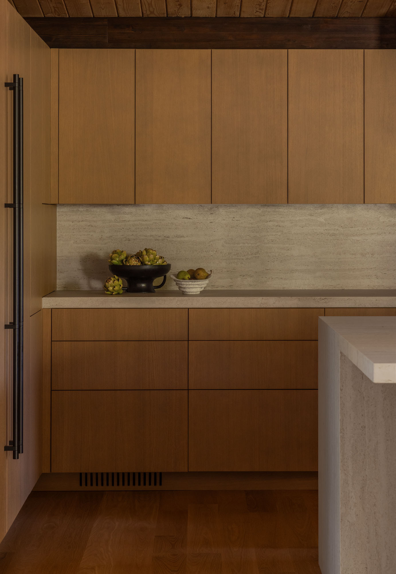 See how Island Crest's open kitchen, dining area, and expanded deck create flexible spaces for entertaining. White oak finishes, Dekton countertops, and an 18-foot sliding glass door blur the line between indoors and out.