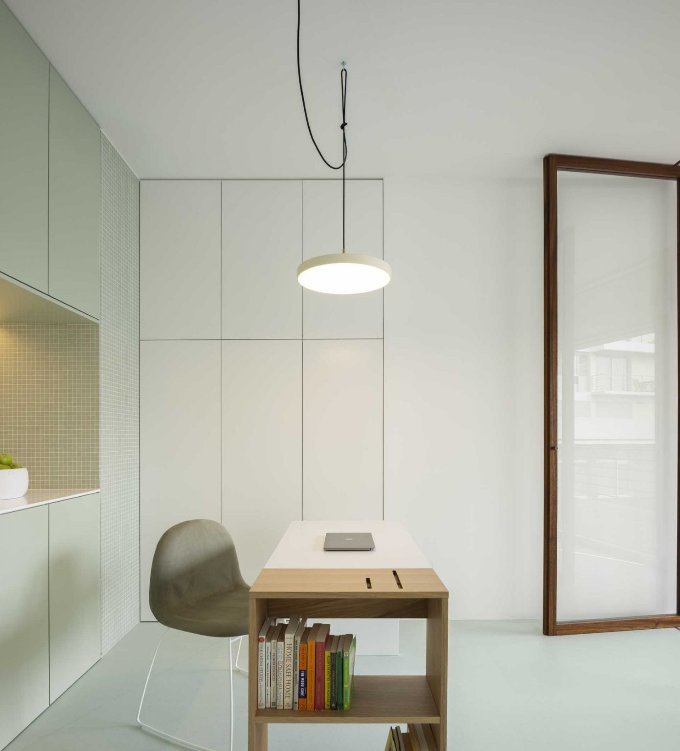 Smart built-in storage, a compact sink area, and clean lines keep this office functional while preserving the clinic's minimalist aesthetic.