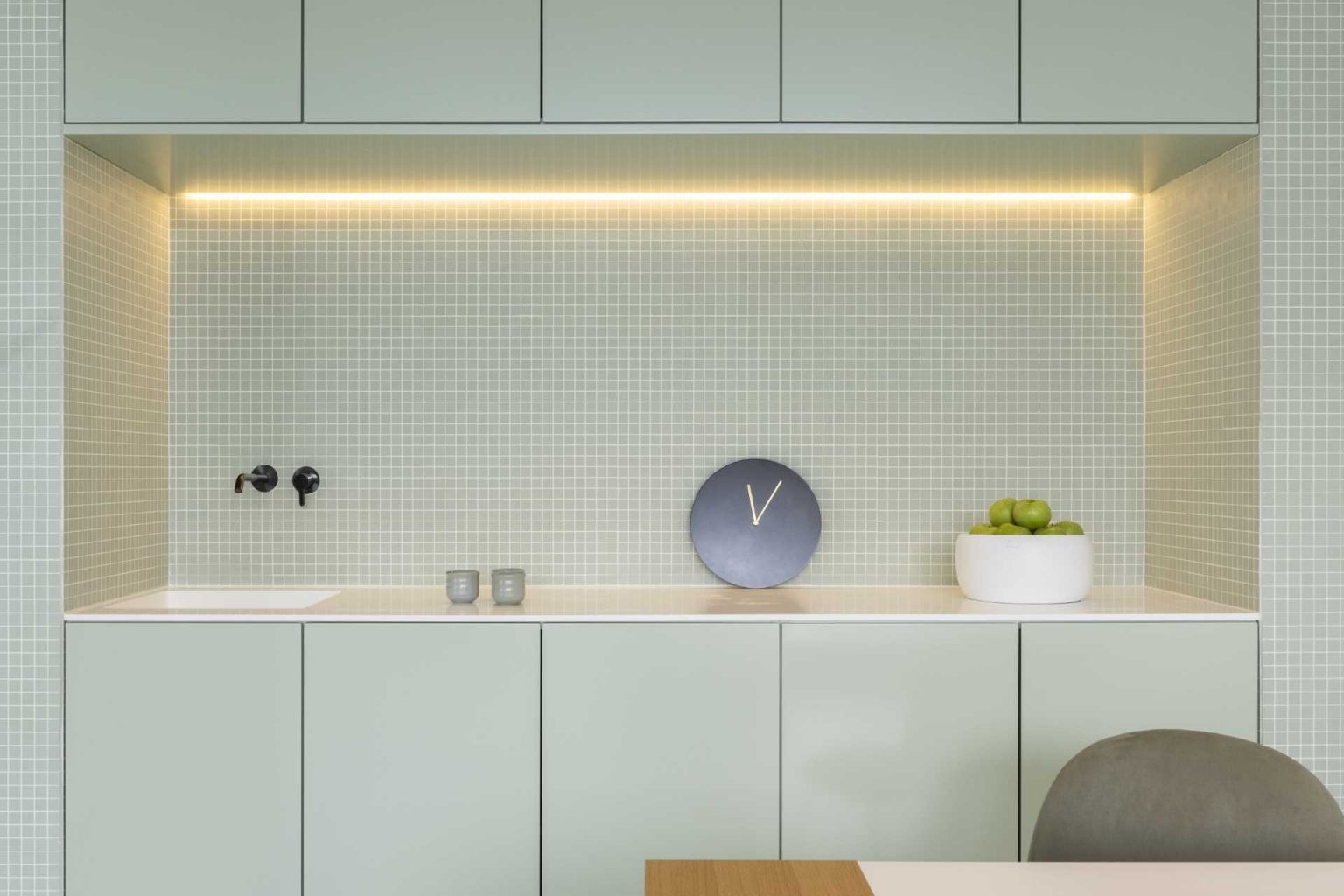 Smart built-in storage, a compact sink area, and clean lines keep this office functional while preserving the clinic's minimalist aesthetic.