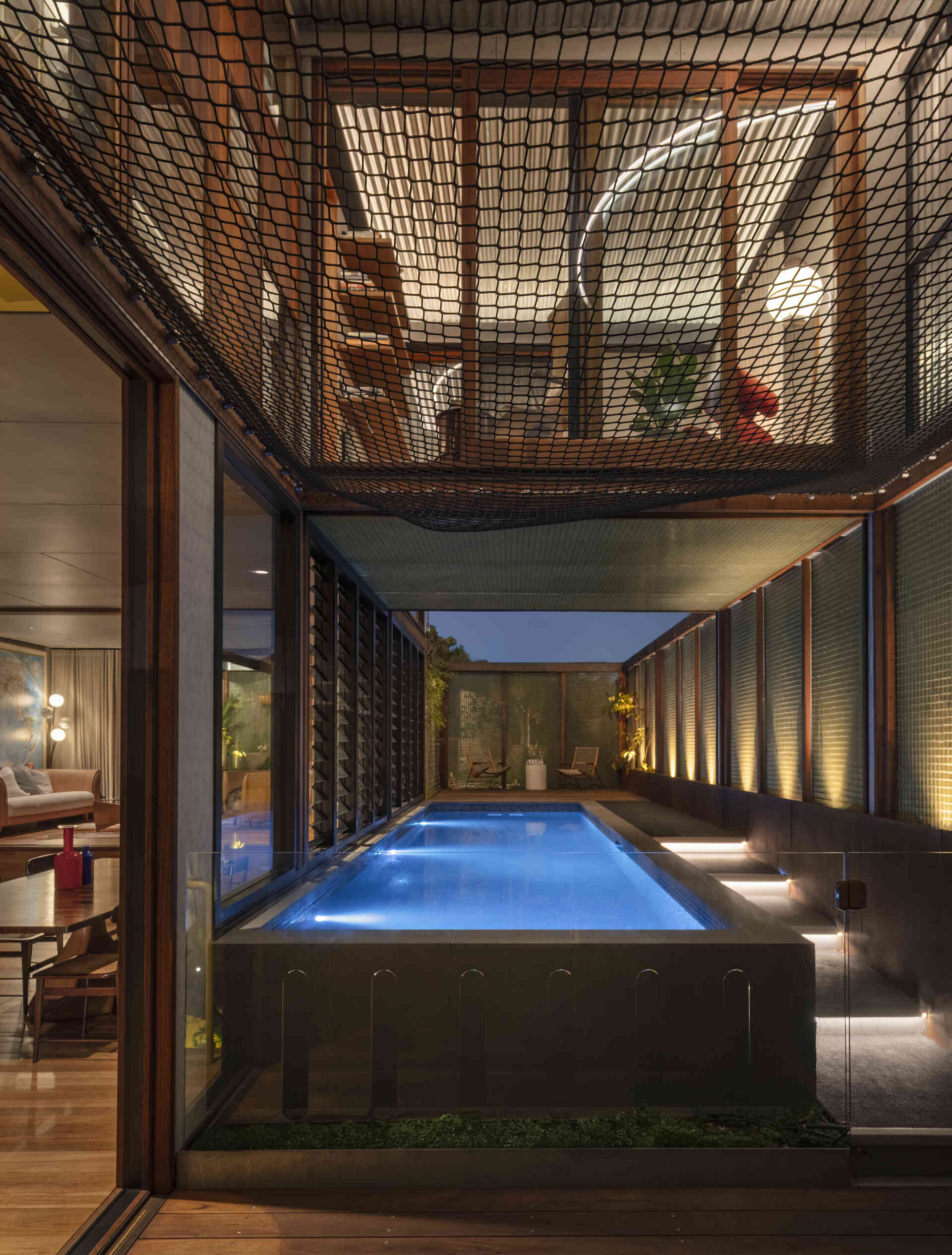 A suspended cargo net above the pool transforms unused airspace into a fun family hangout with incredible views.