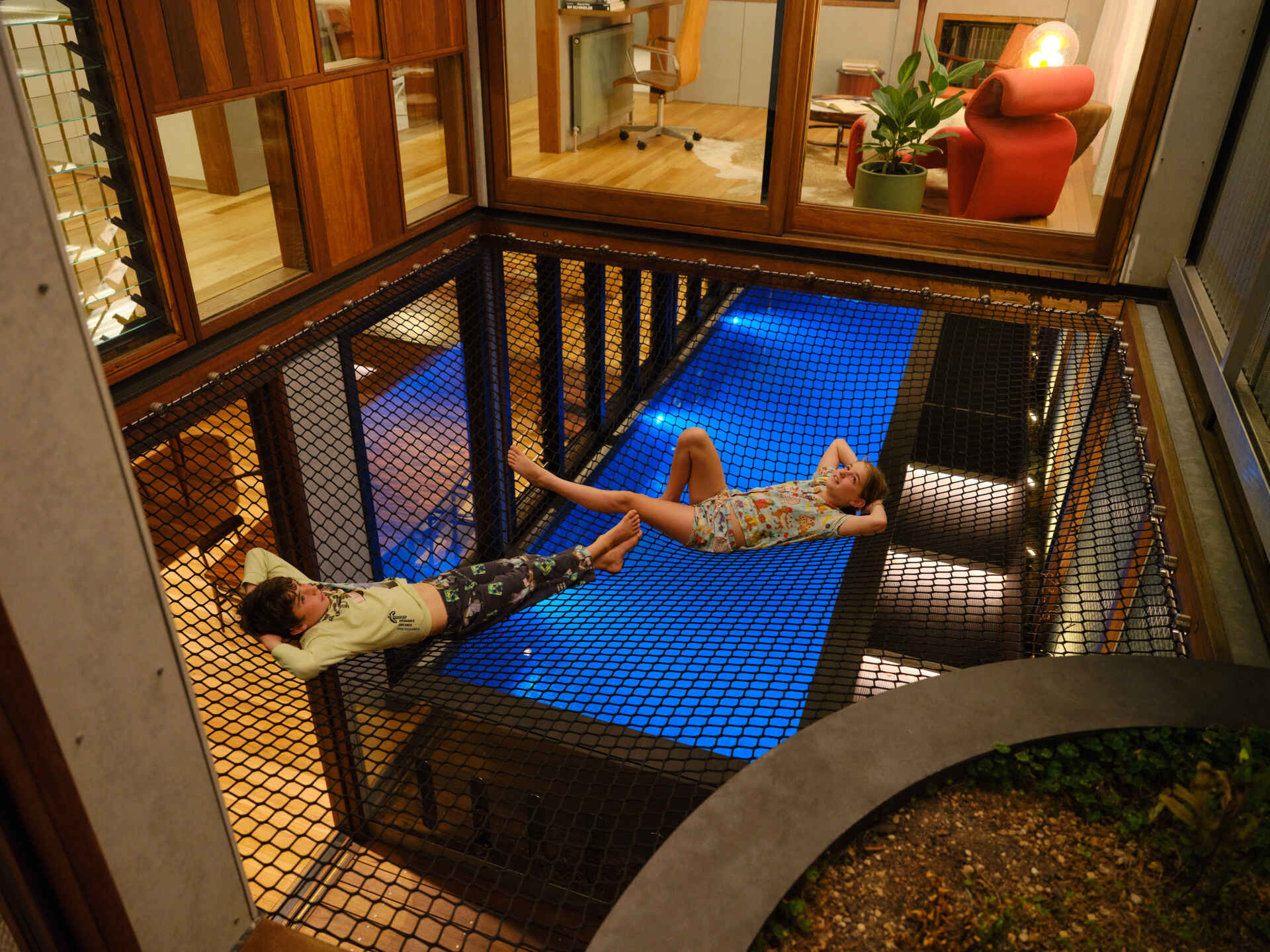 A suspended cargo net above the pool transforms unused airspace into a fun family hangout with incredible views.