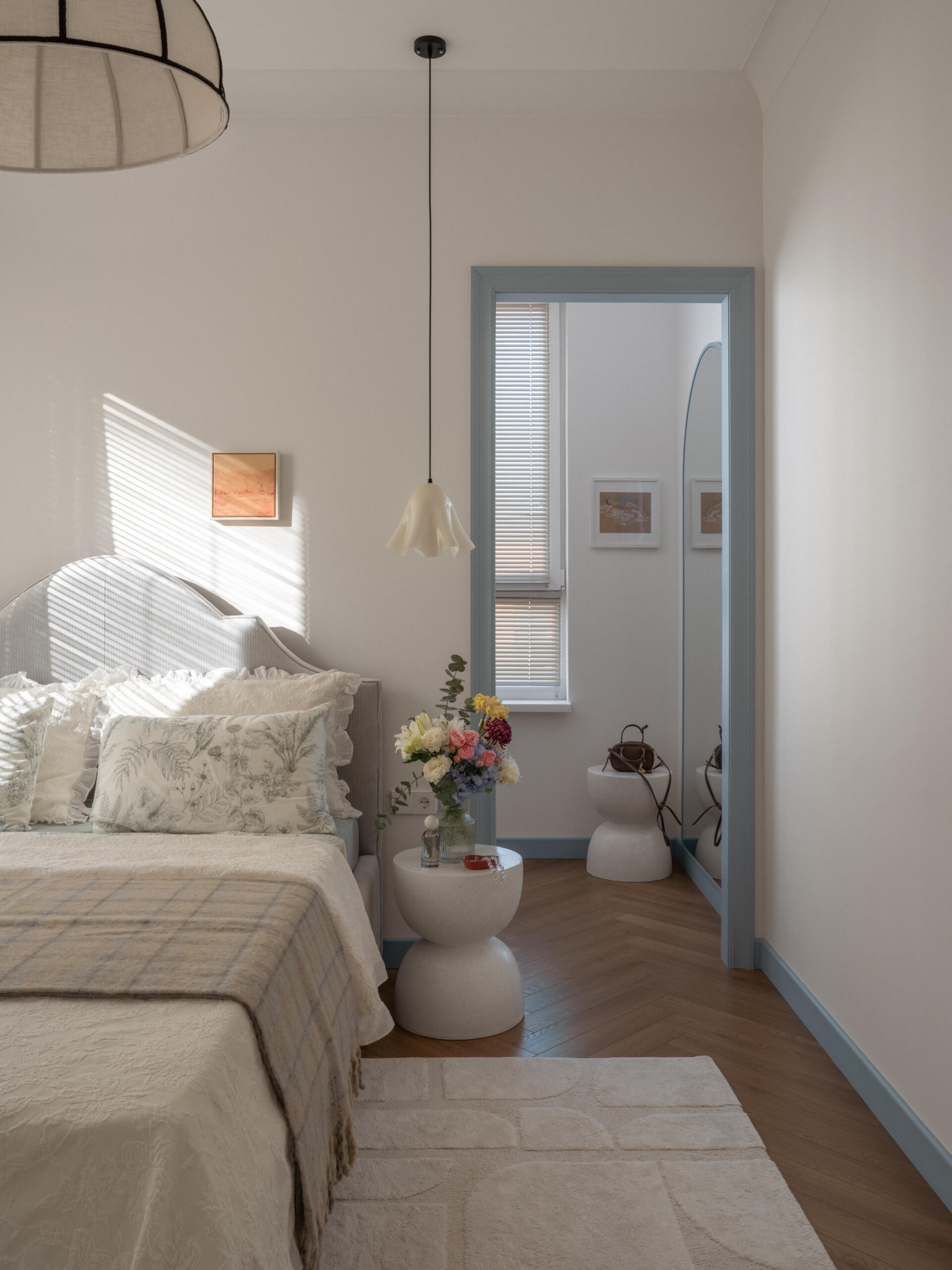 A calming bedroom designed with soft colors and natural light creates a peaceful space for rest and relaxation.