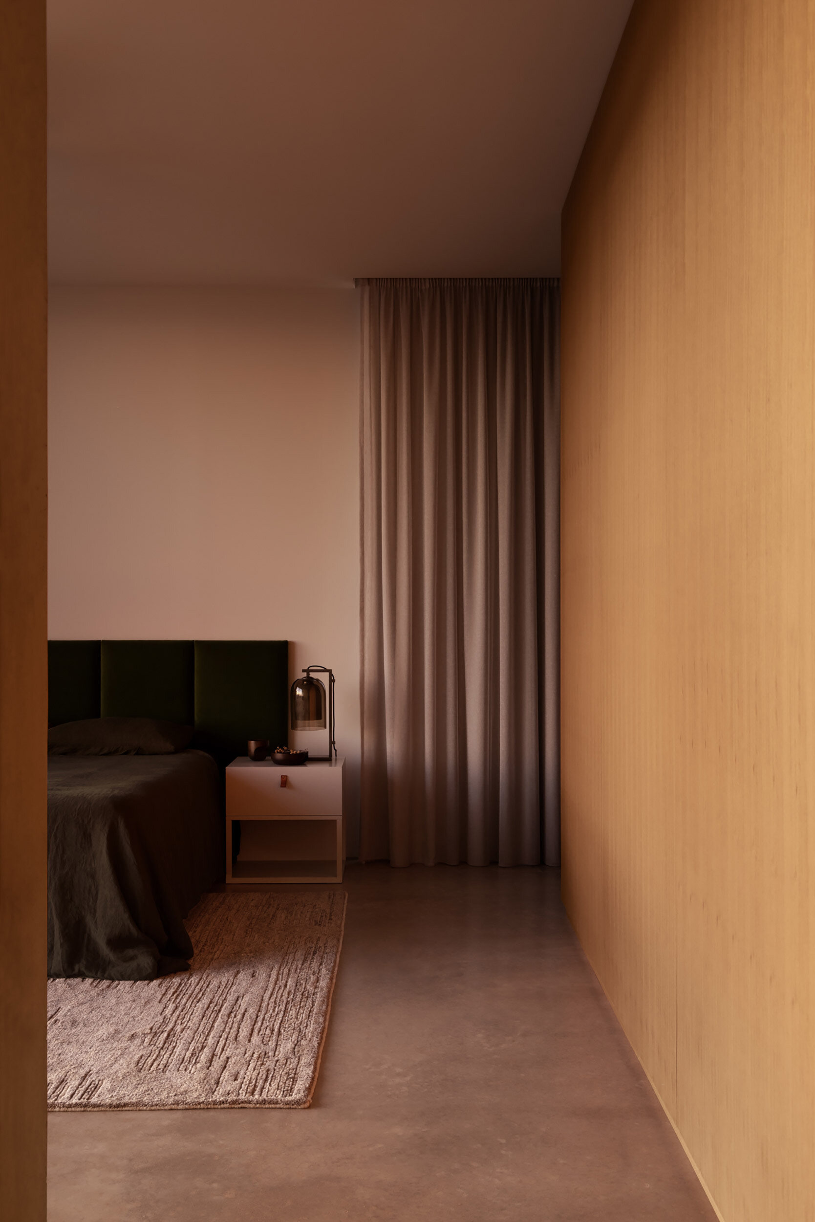 The bedroom is oriented toward the surrounding scenery, allowing the dramatic views to become a defining feature of the space. Large openings bring natural light deep into the room while maintaining a strong visual connection to the landscape.