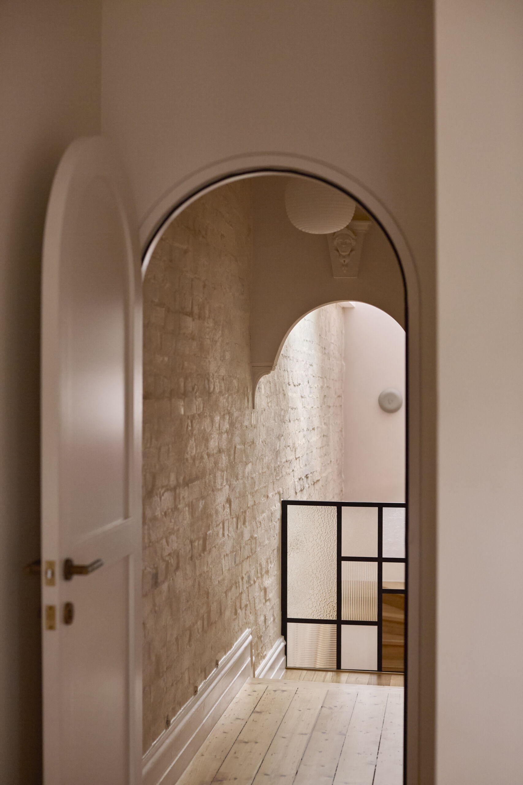 Restored Victorian arches and plaster detailing in a renovated terrace home, showing heritage craftsmanship in Melbourne architecture.