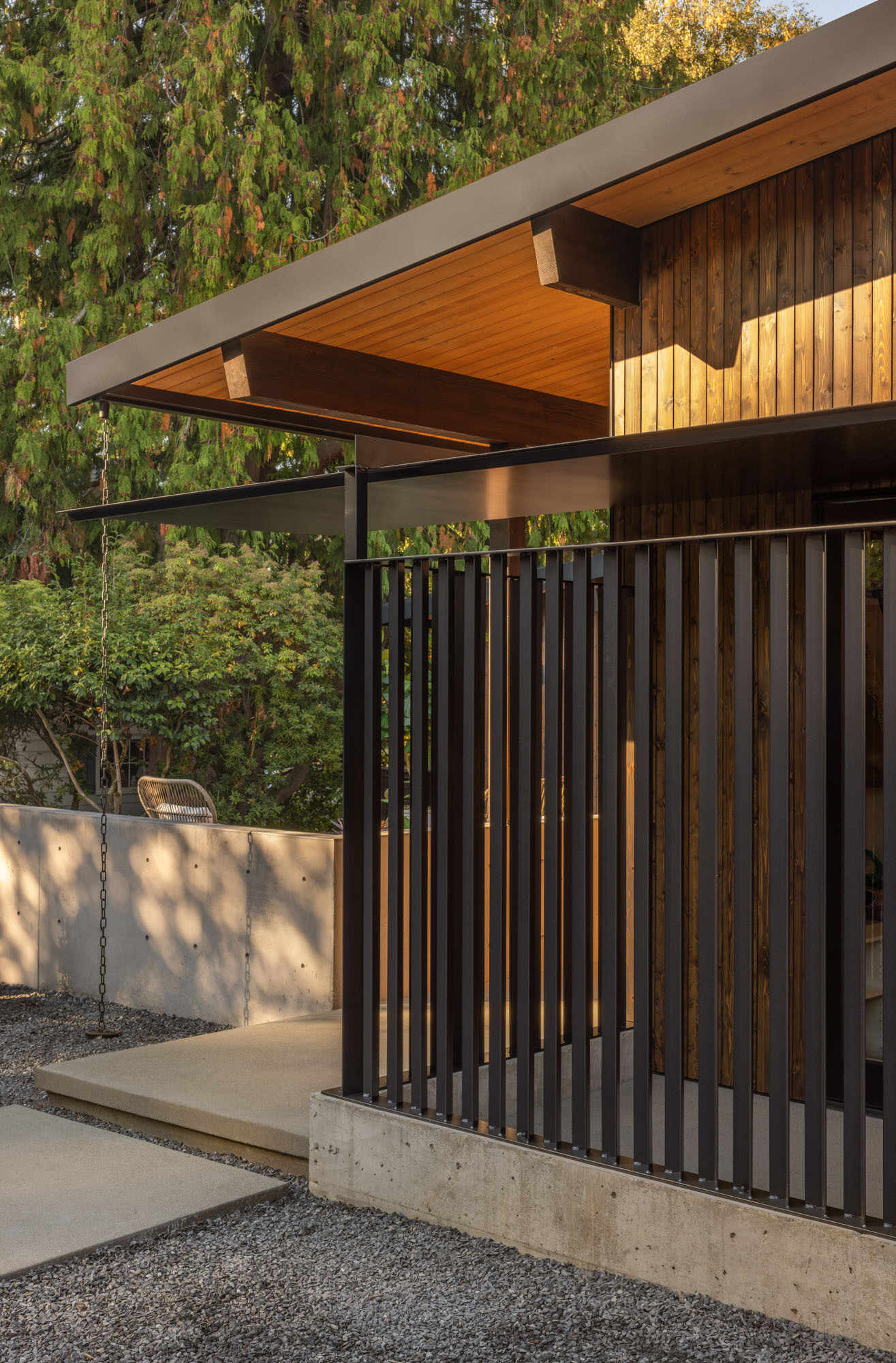 Discover the exterior details that give Island Crest its warm midcentury character, from natural timber cladding to crisp black steel accents that create a welcoming first impression.