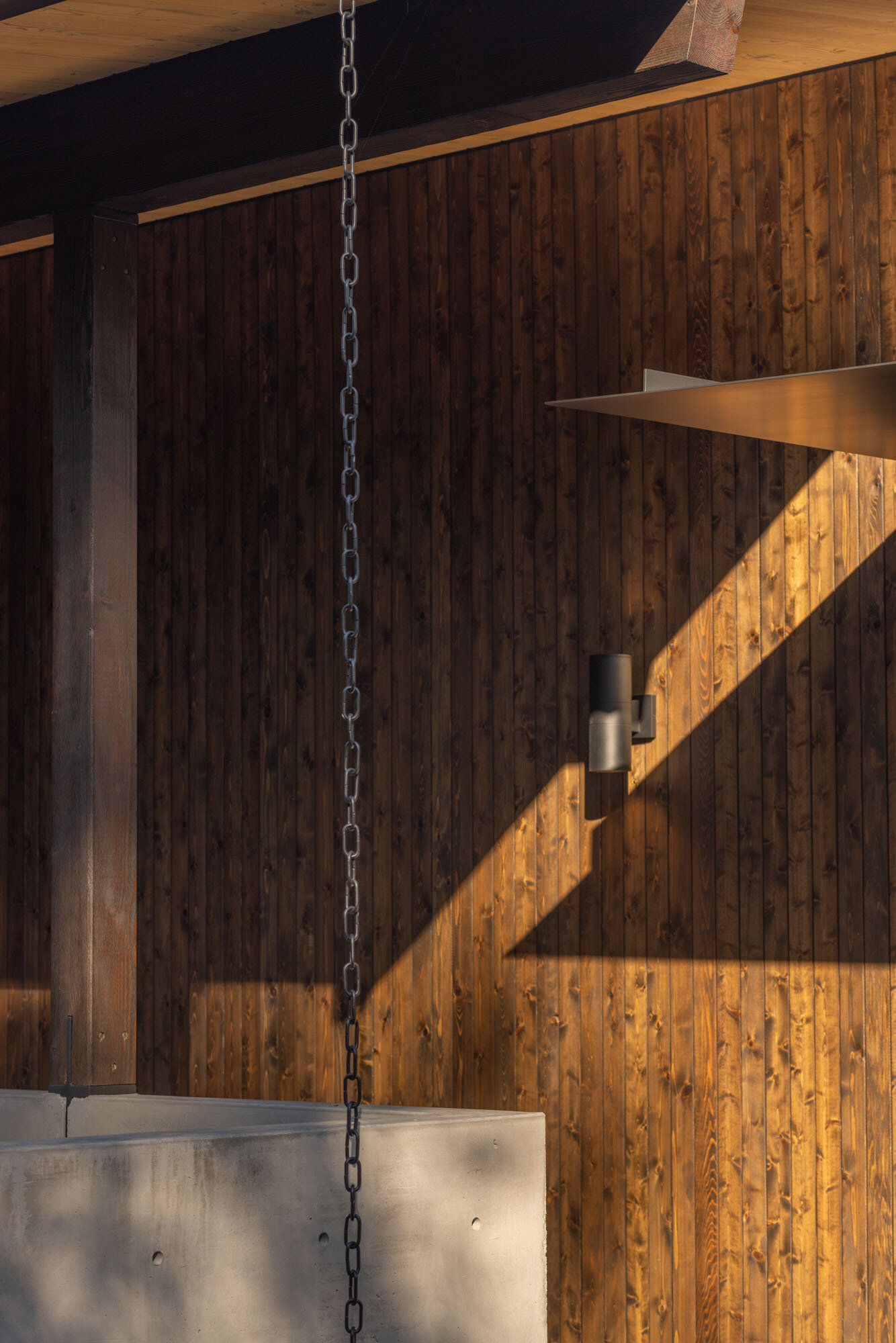Discover the exterior details that give Island Crest its warm midcentury character, from natural timber cladding to crisp black steel accents that create a welcoming first impression.