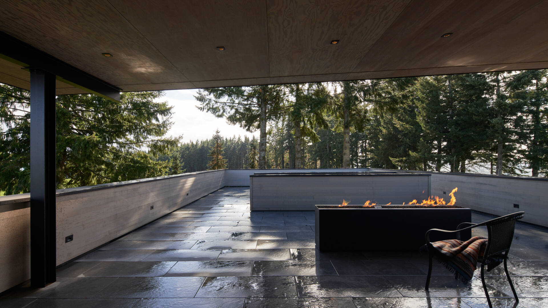 Offering 270-degree views, the rooftop space includes a fireplace and serves as an all-season entertaining area with panoramic outlooks toward both the city and wine country.