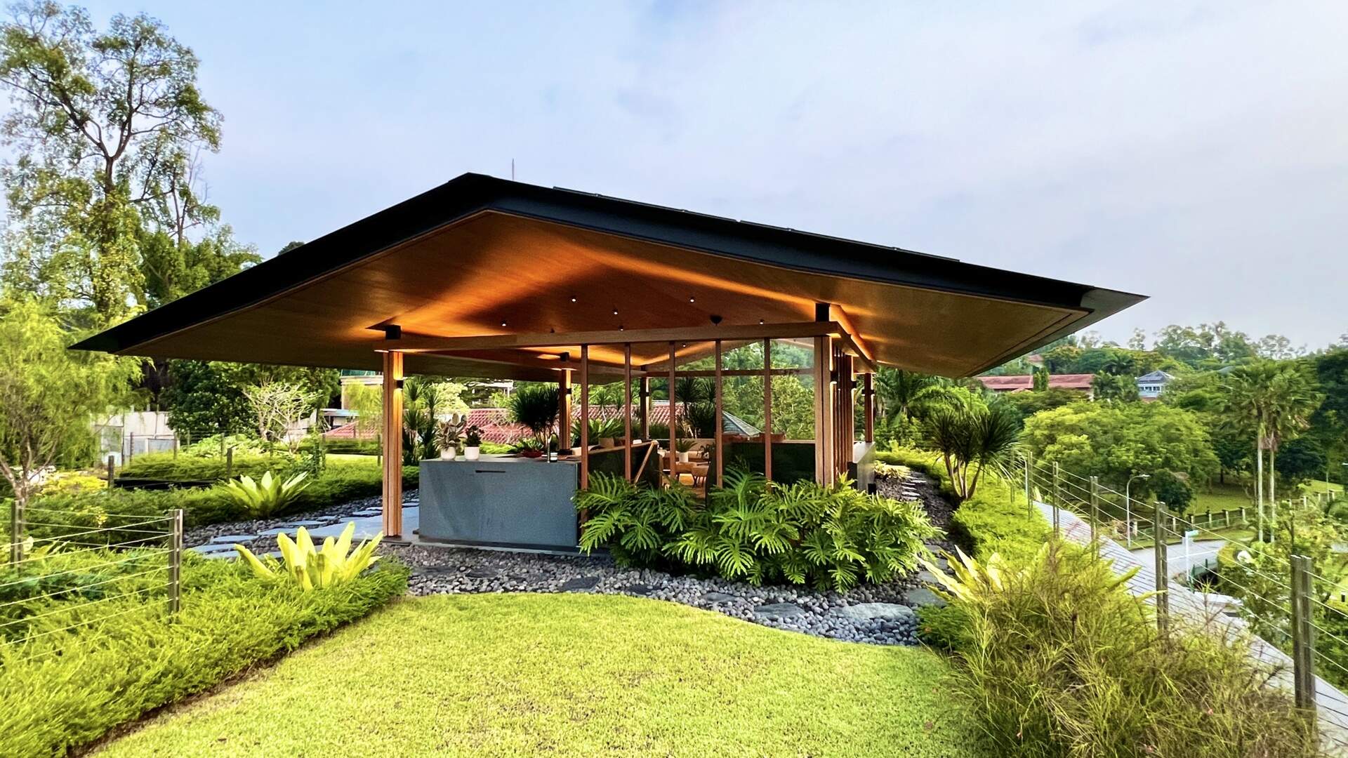 Sky Pavilion House by Guz Architects transforms an unusual Singapore site into a lush garden-focused home with a rooftop pavilion, glass staircase, swimming pool, and smart passive cooling features. Discover how greenery, natural breezes, and tropical design come together in this stunning residence.
