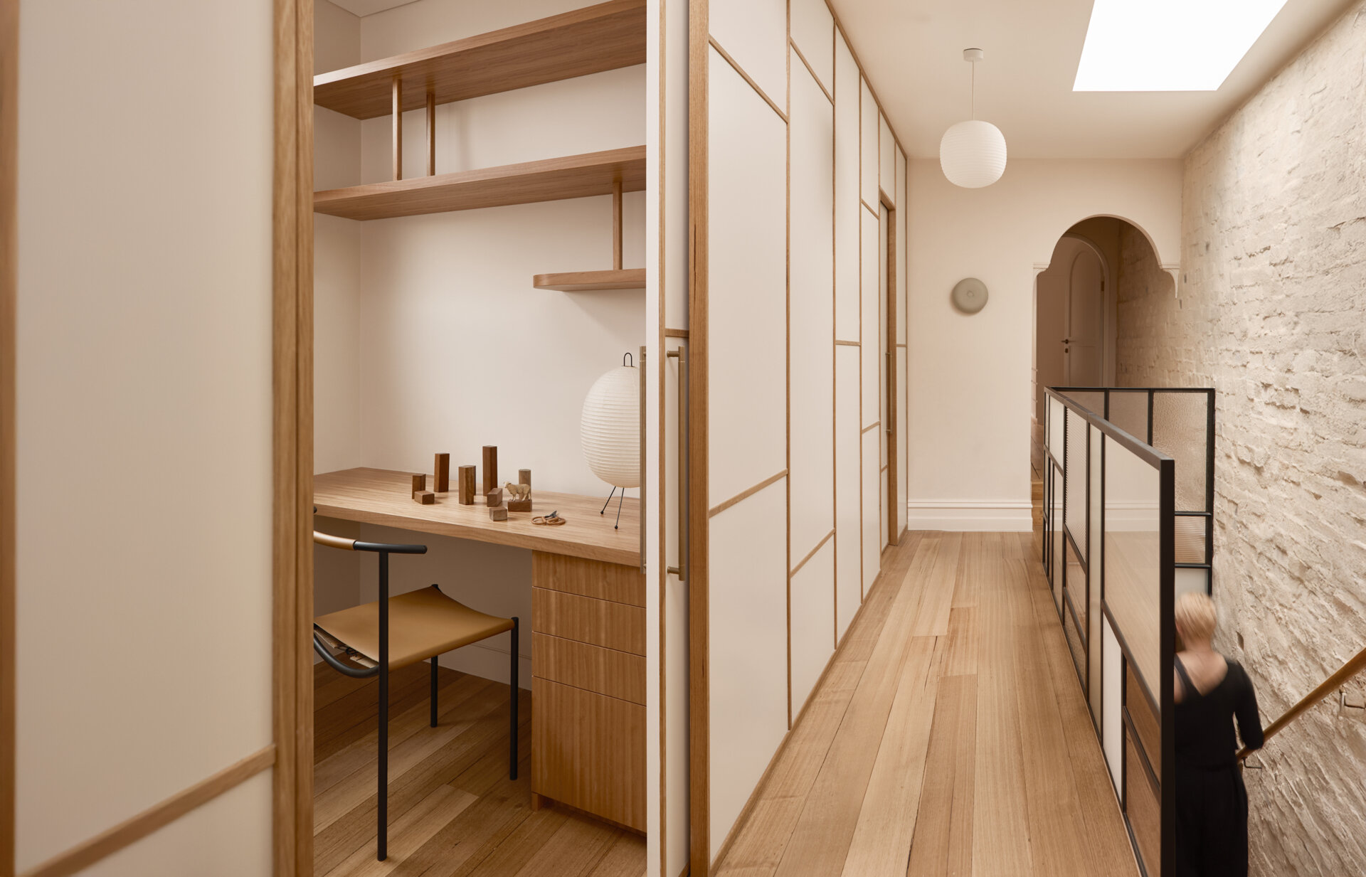 An upstairs hallway with shoji-style partitions concealing a study, blending Japanese influence with Victorian terrace structure.