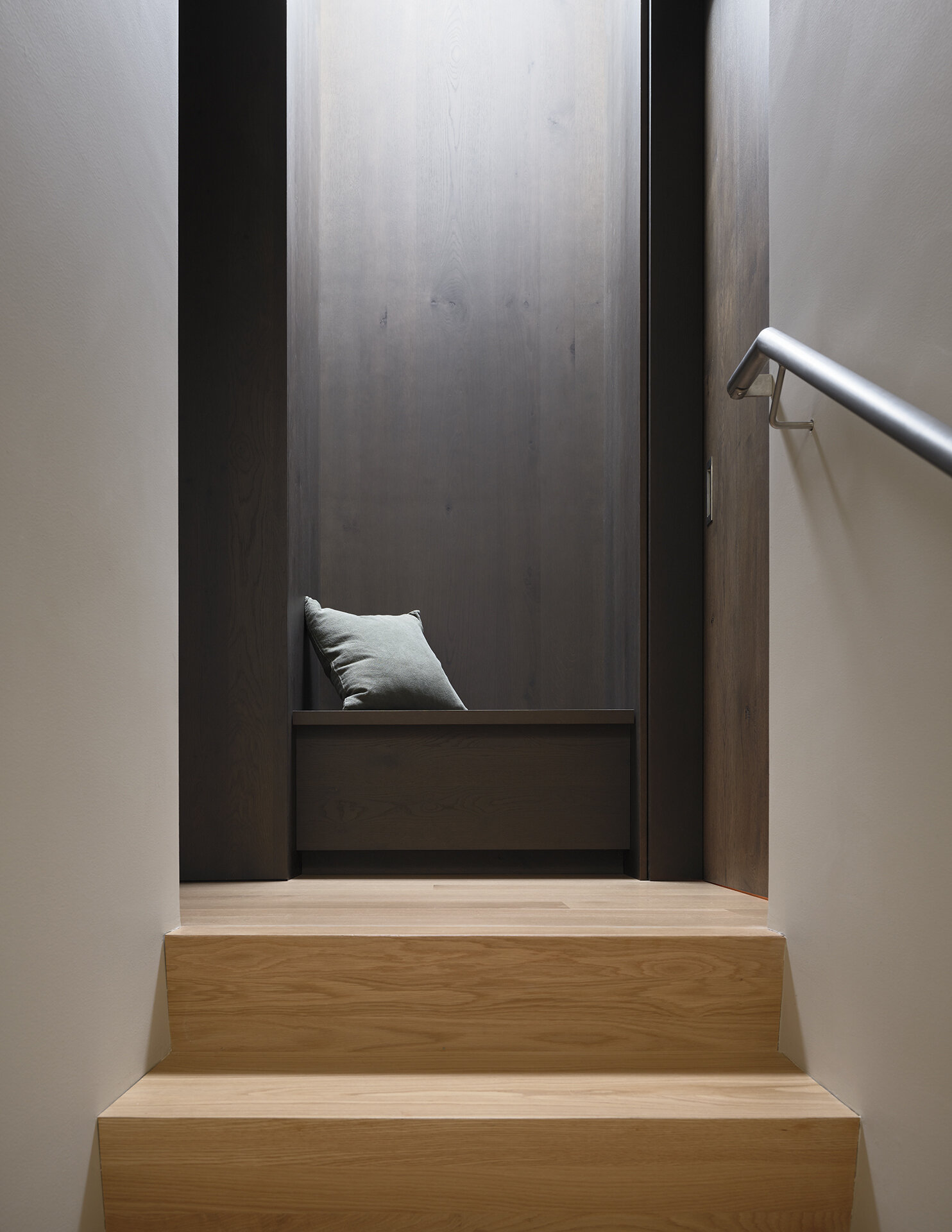 A built-in bench at the top of the stairs adds functionality while making smart use of space.