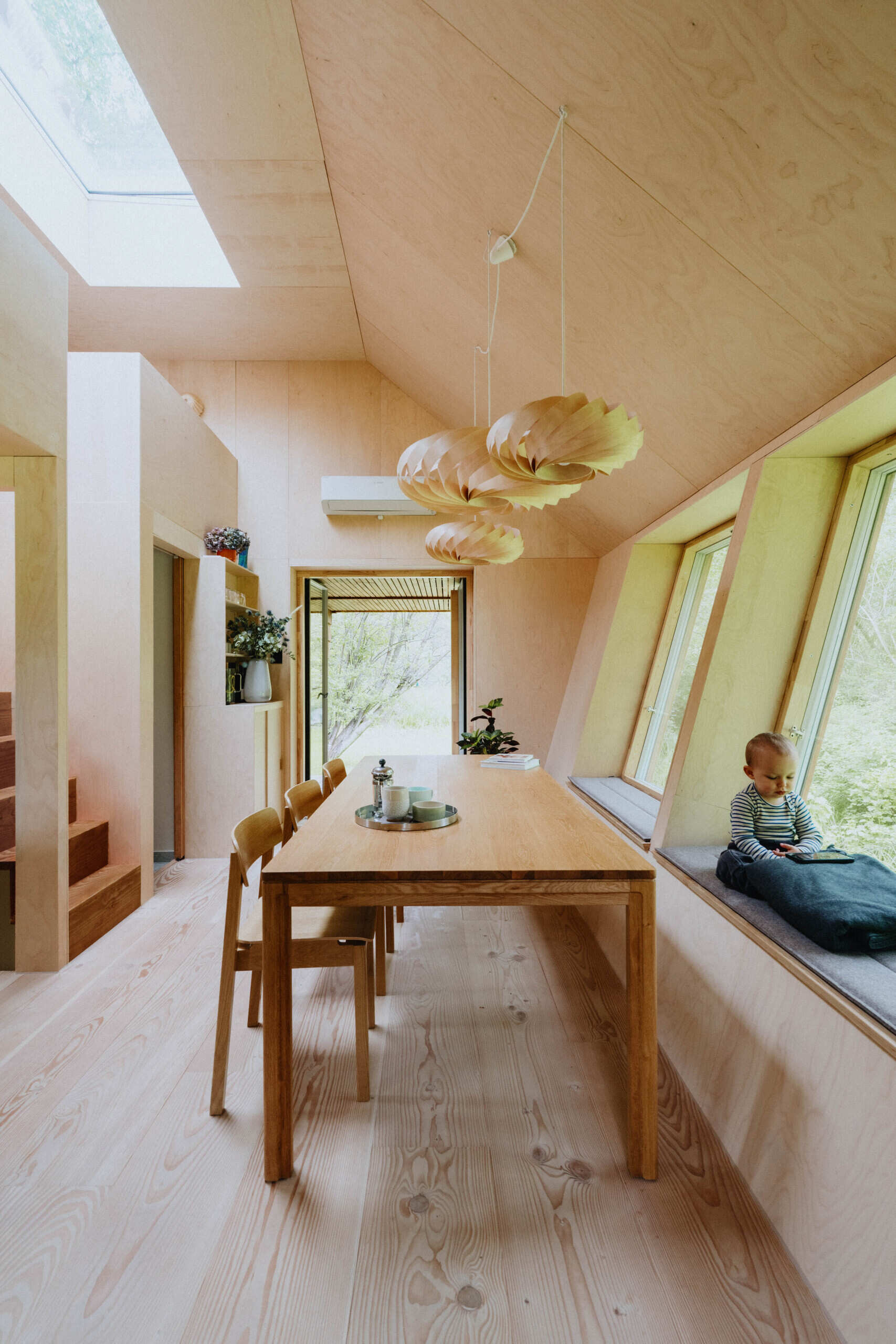 A compact living room that comfortably seats ten people proves small homes can still be highly social.
