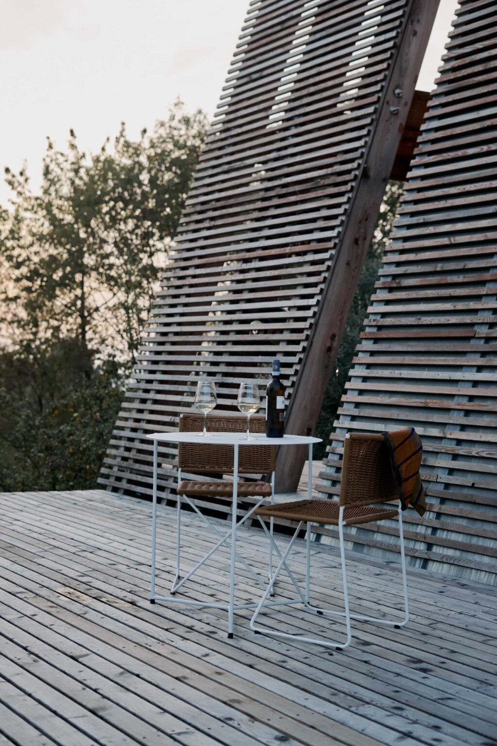 Inspired by traditional haystacks, these contemporary timber cabins combine an A-shaped structure, floor-to-ceiling glazing, and prefabricated construction to create a striking eco-hotel in Italy.