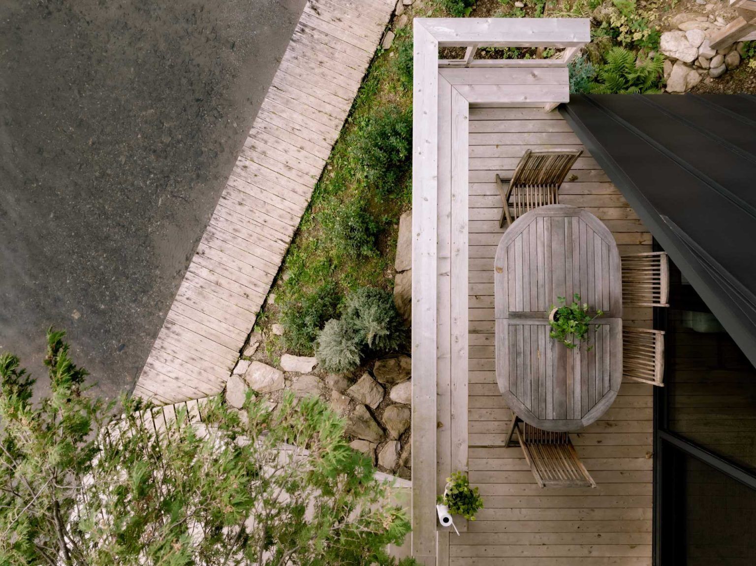 This lakeside deck extends the living space outdoors with a simple dining area and direct access to the water. Small outdoor spaces don't get much better than this.