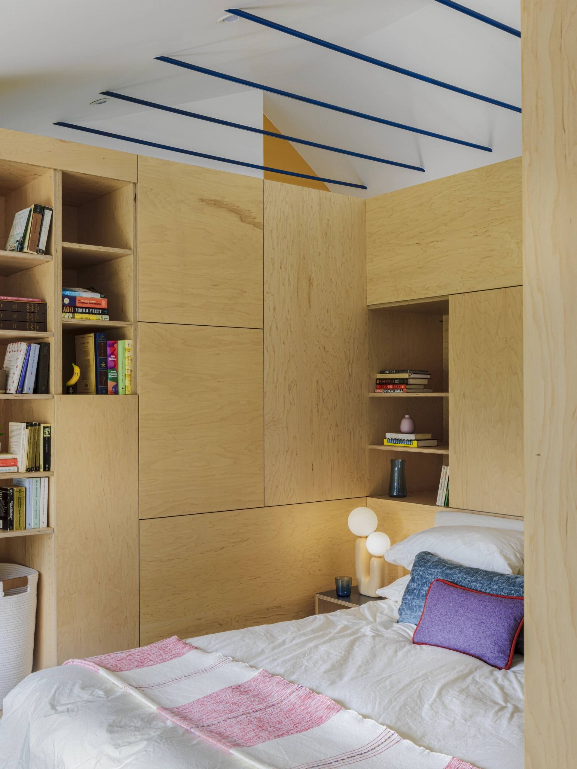 A hidden bedroom and sunny window seat show how custom cabinetry can completely transform a small home.