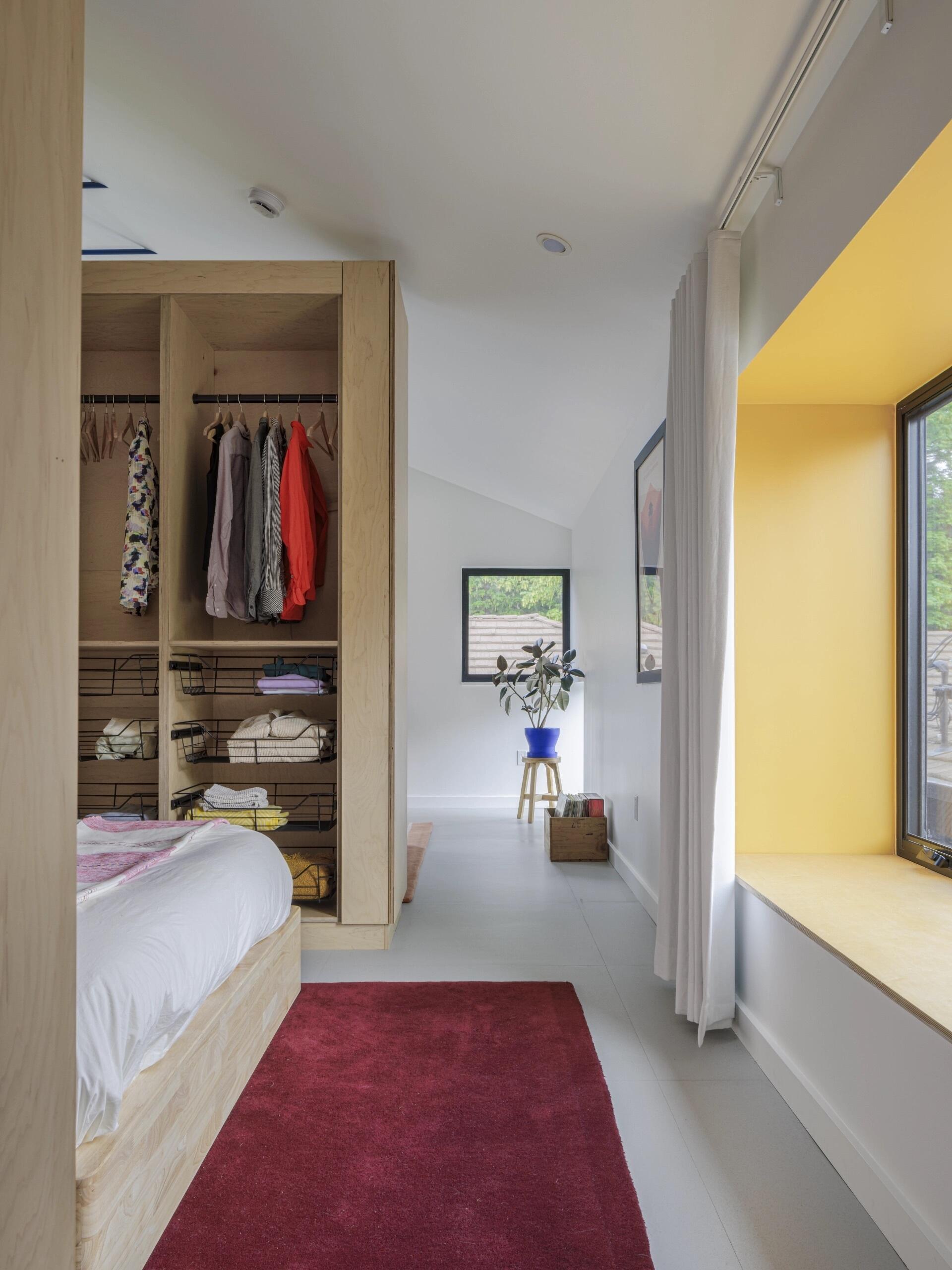 A hidden bedroom and sunny window seat show how custom cabinetry can completely transform a small home.