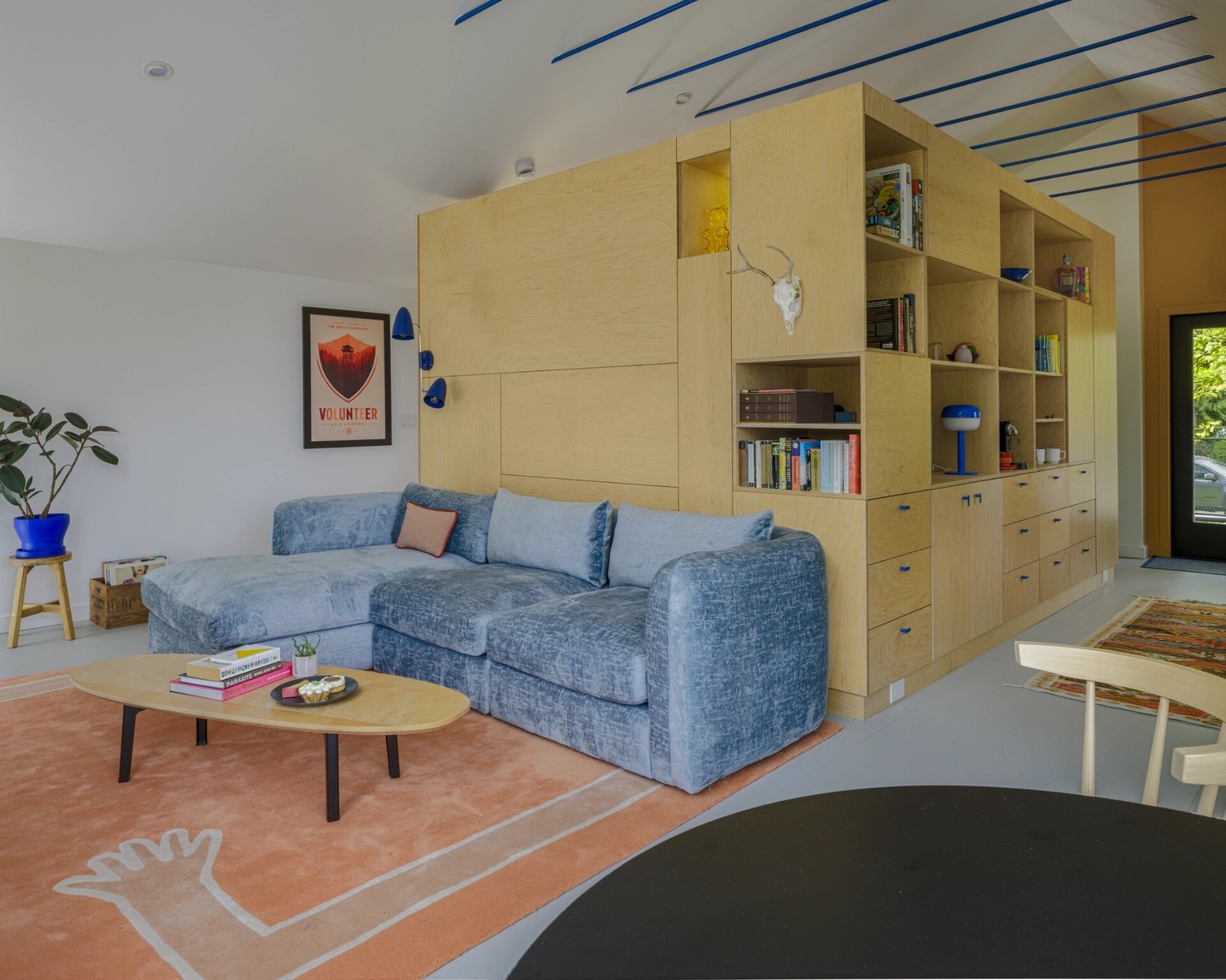High ceilings and lake views help this small Seattle studio living room feel surprisingly spacious.