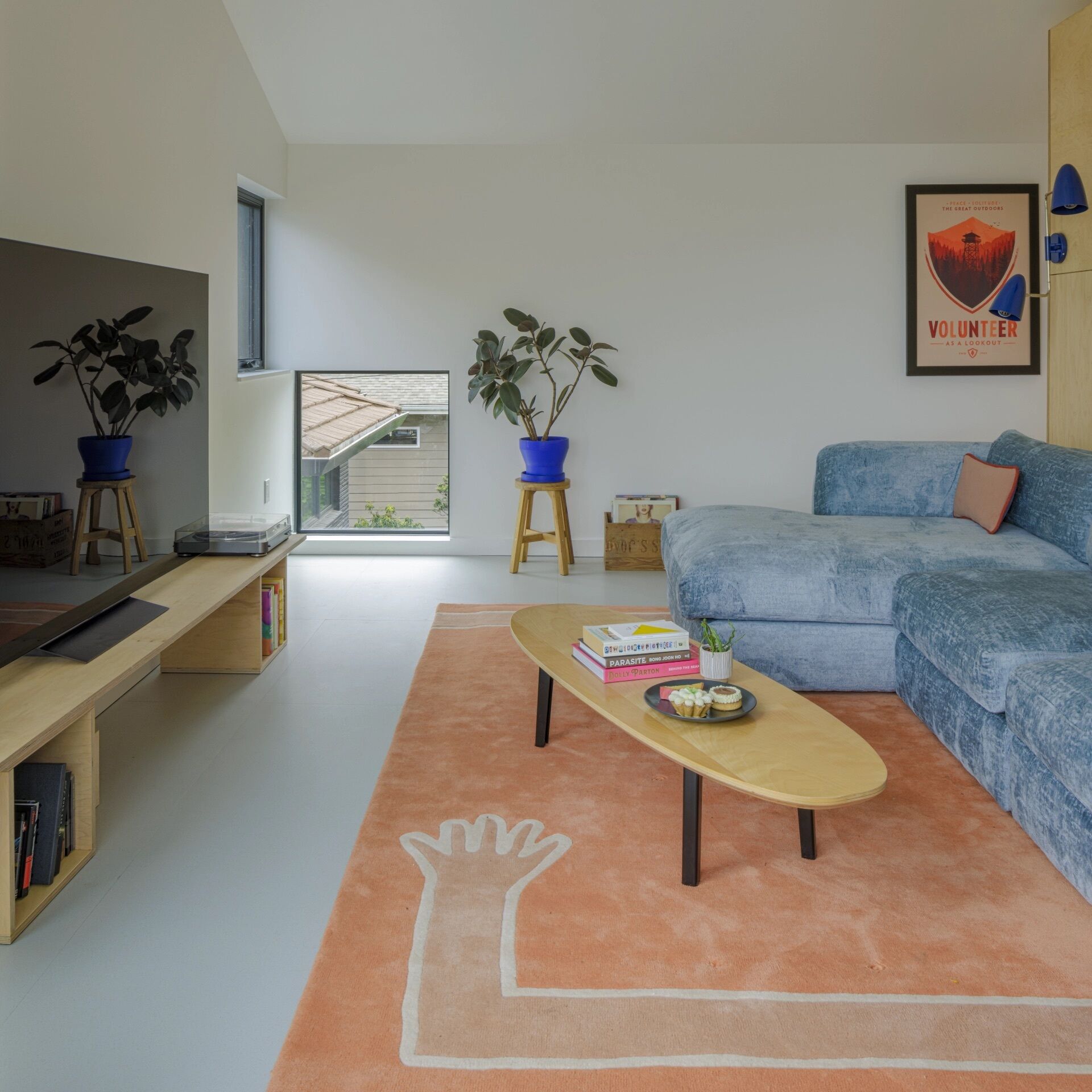 High ceilings and lake views help this small Seattle studio living room feel surprisingly spacious.