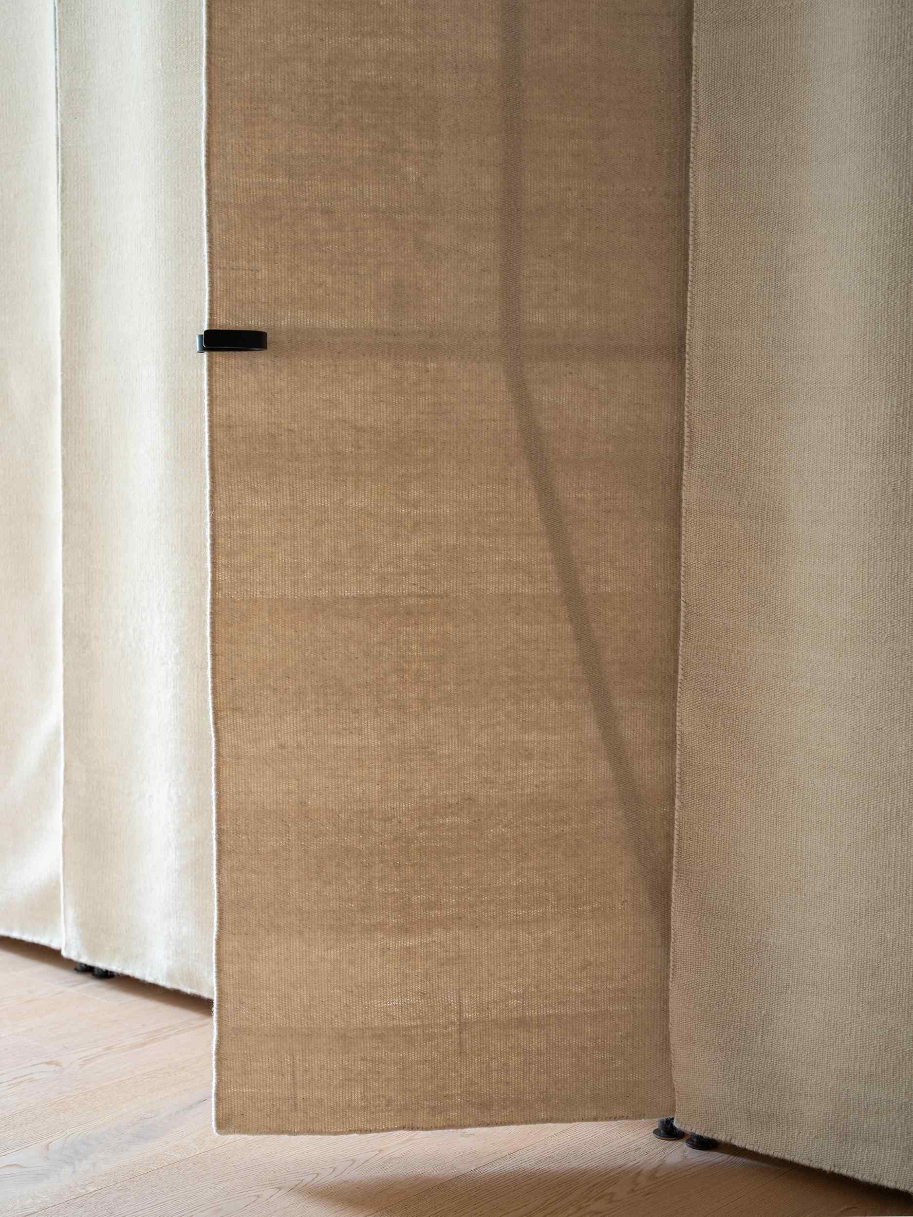 Rug-fronted closet doors bring texture and softness to this beautifully crafted bedroom.