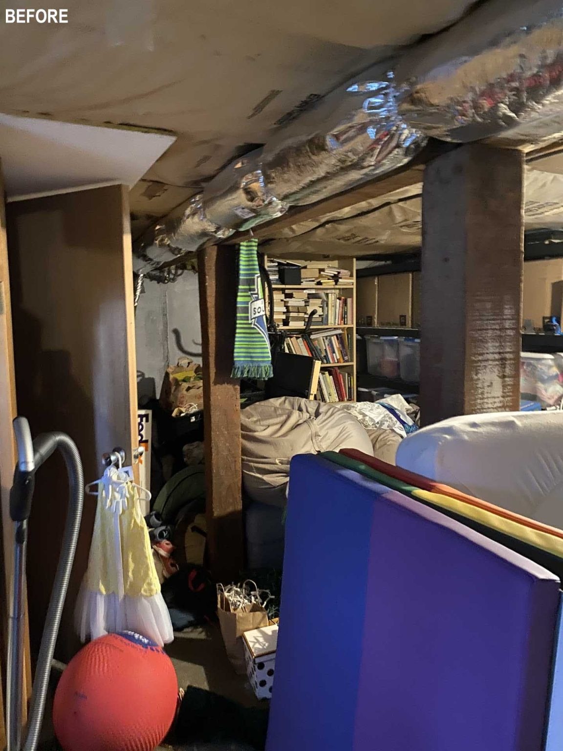 BEFORE - This once-dark basement now serves as a bright playroom, family lounge, guest room, and storage area all in one flexible space.