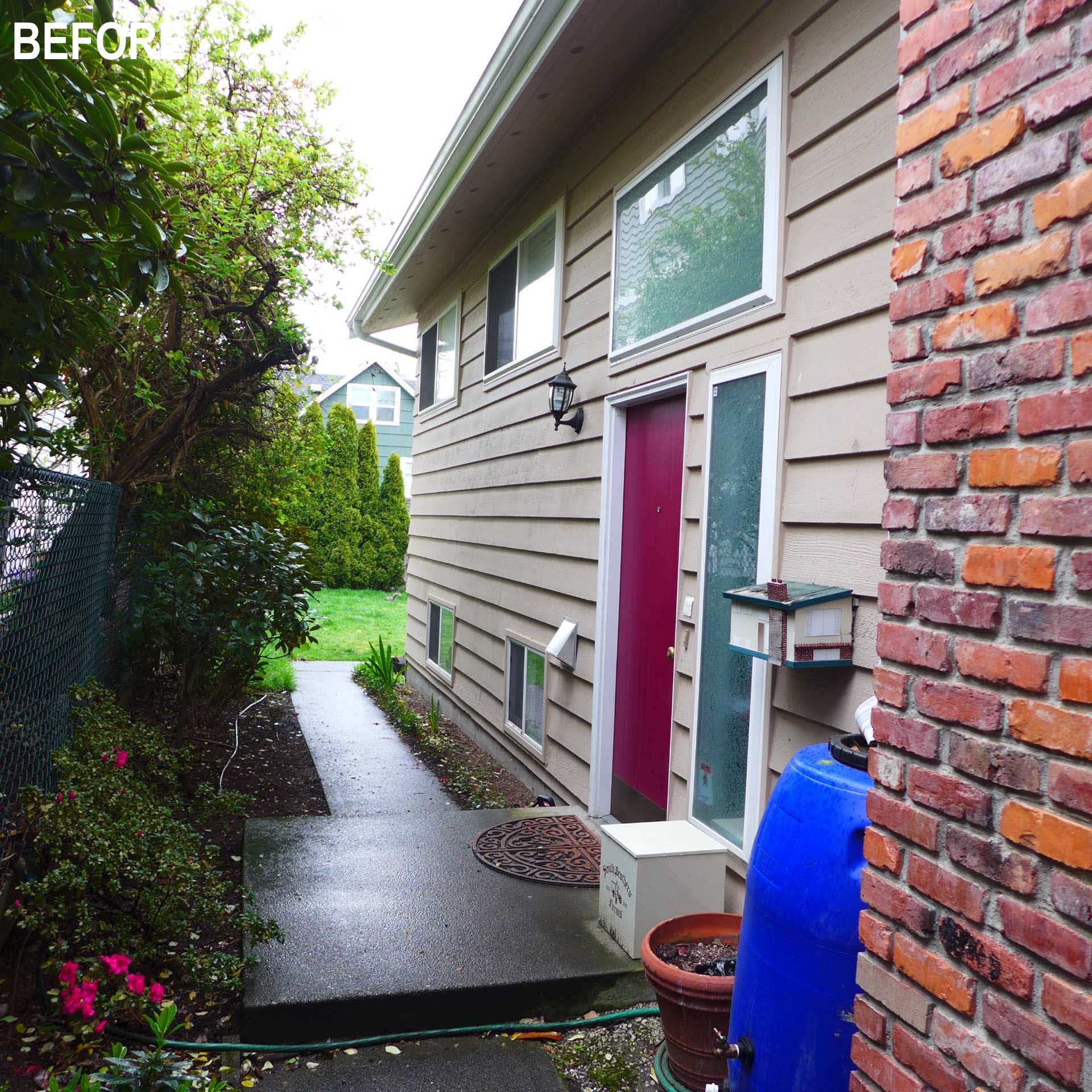 BEFORE- A colorful new front entry, warm wood siding, larger windows, and a welcoming façade completely change the street presence of this renovated Seattle home.