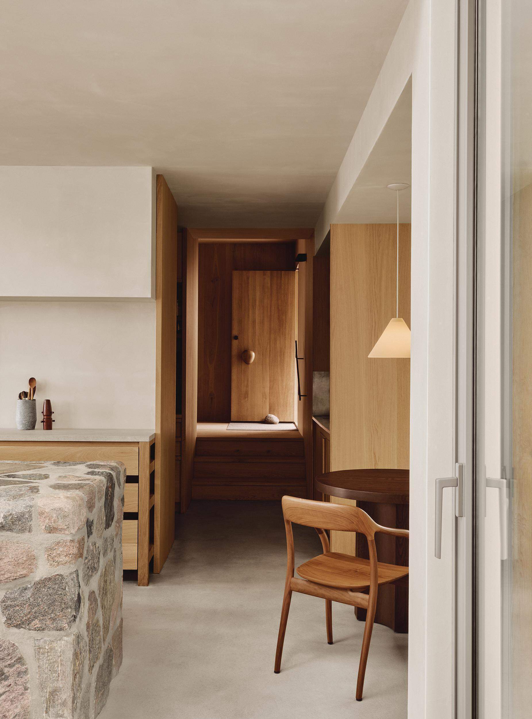A charming breakfast nook adds another welcoming gathering spot beside the stunning kitchen.