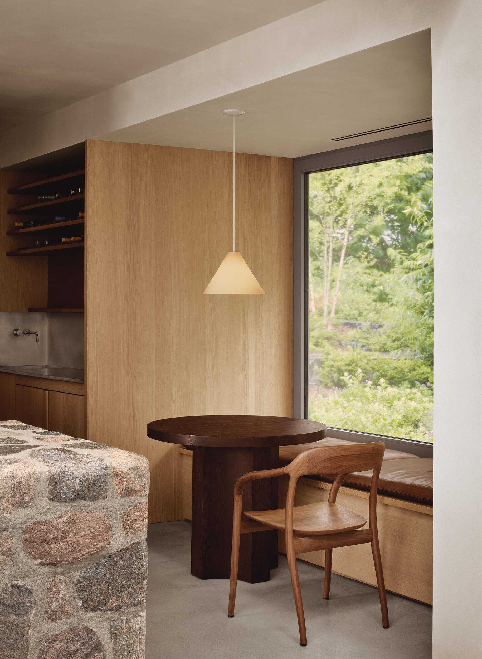 A charming breakfast nook adds another welcoming gathering spot beside the stunning kitchen.