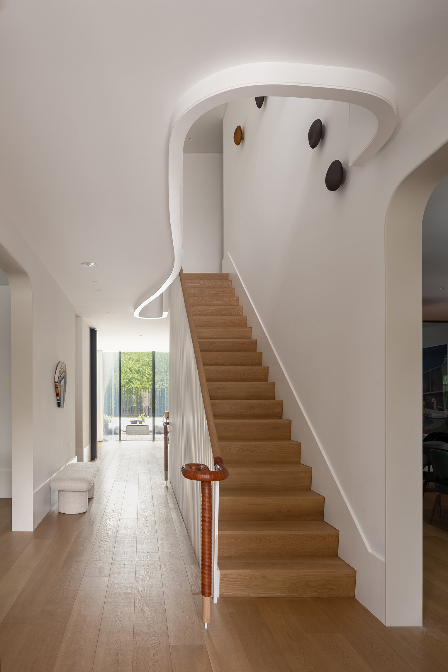 Sculptural stairs and a flowing second-floor hallway create one of the most memorable architectural moments in Snider House.
