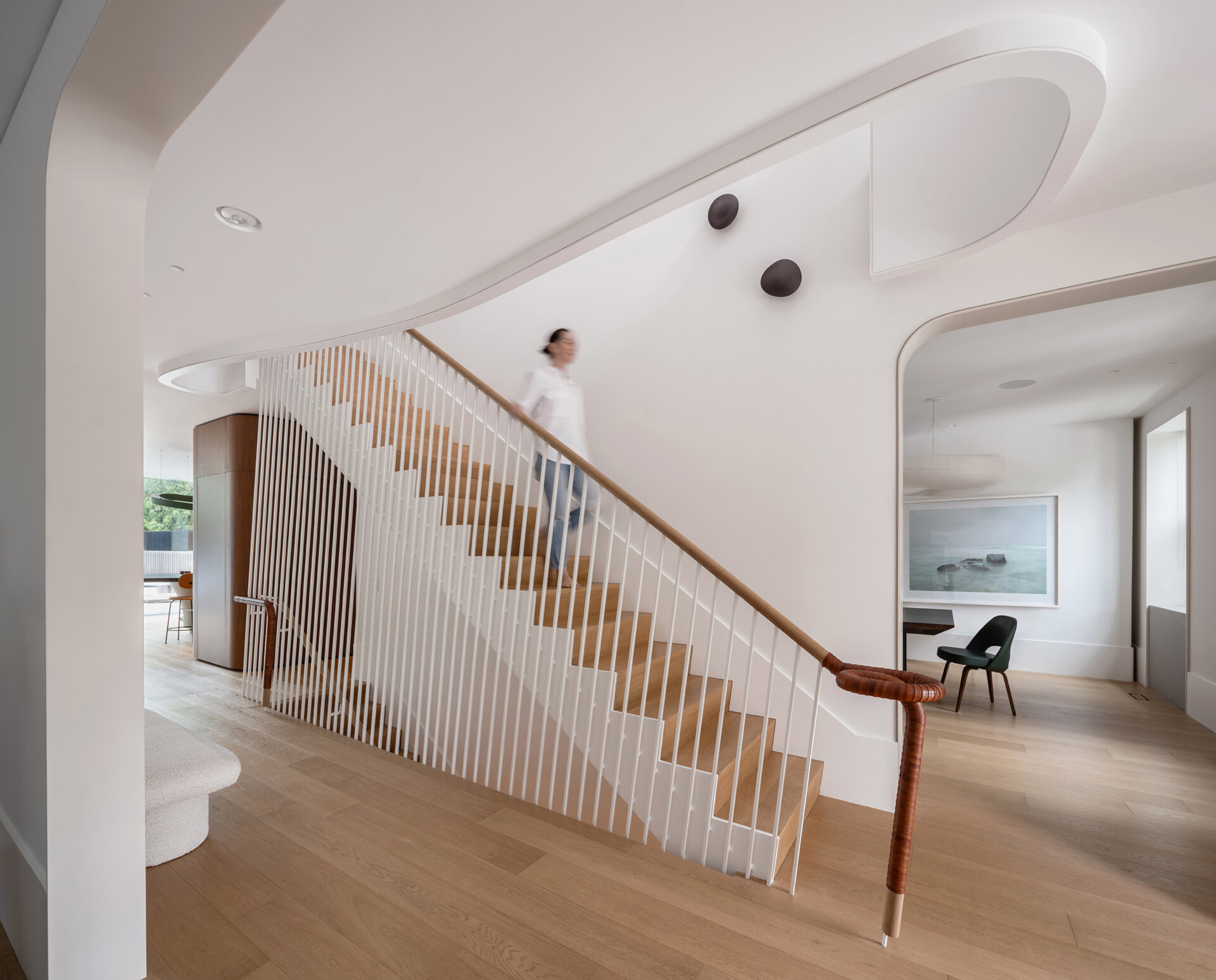 A bright Toronto foyer where historic symmetry meets contemporary materials and luminous Corian-lined doorways.