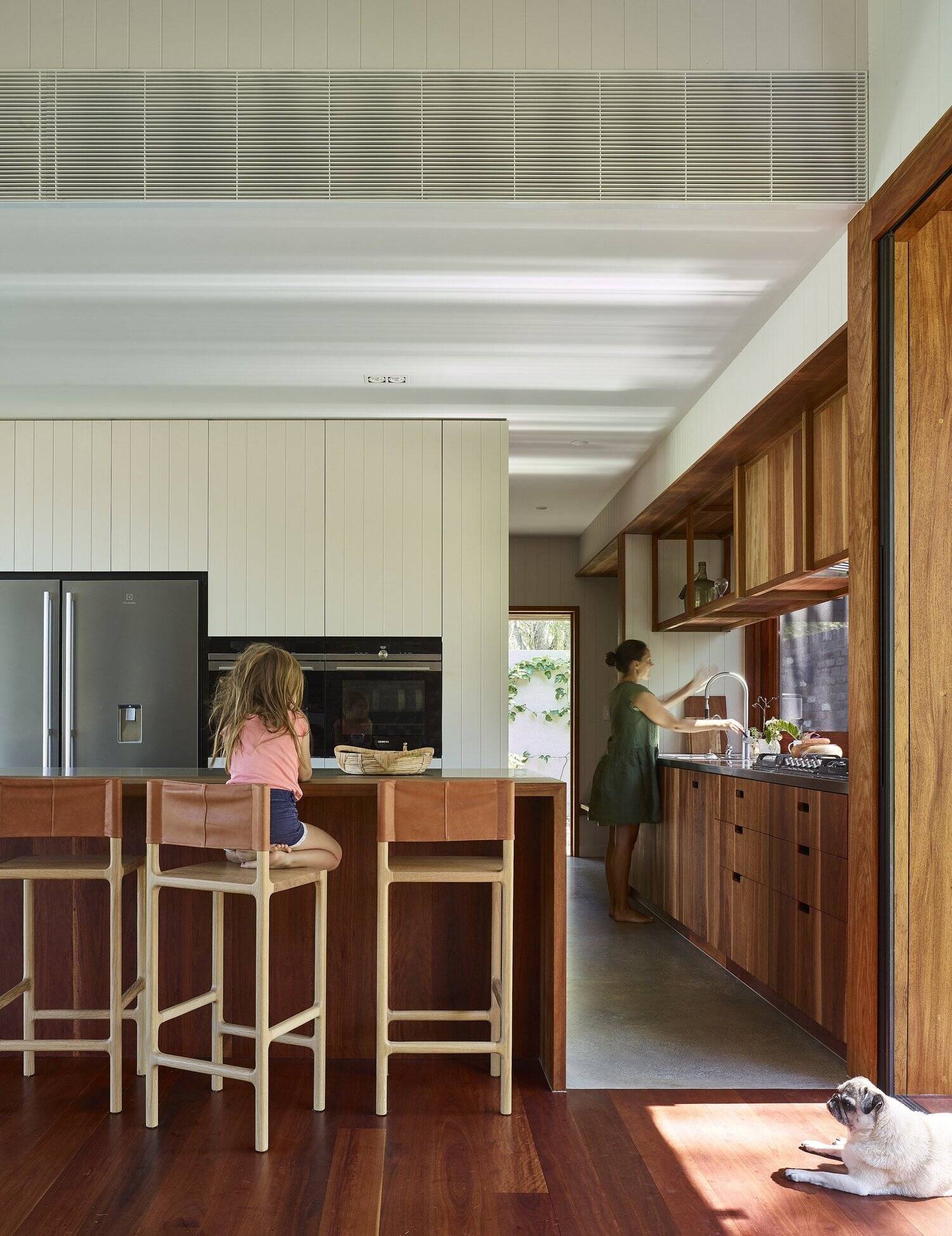 This timber kitchen replaces a traditional backsplash with large windows overlooking the Australian bush.