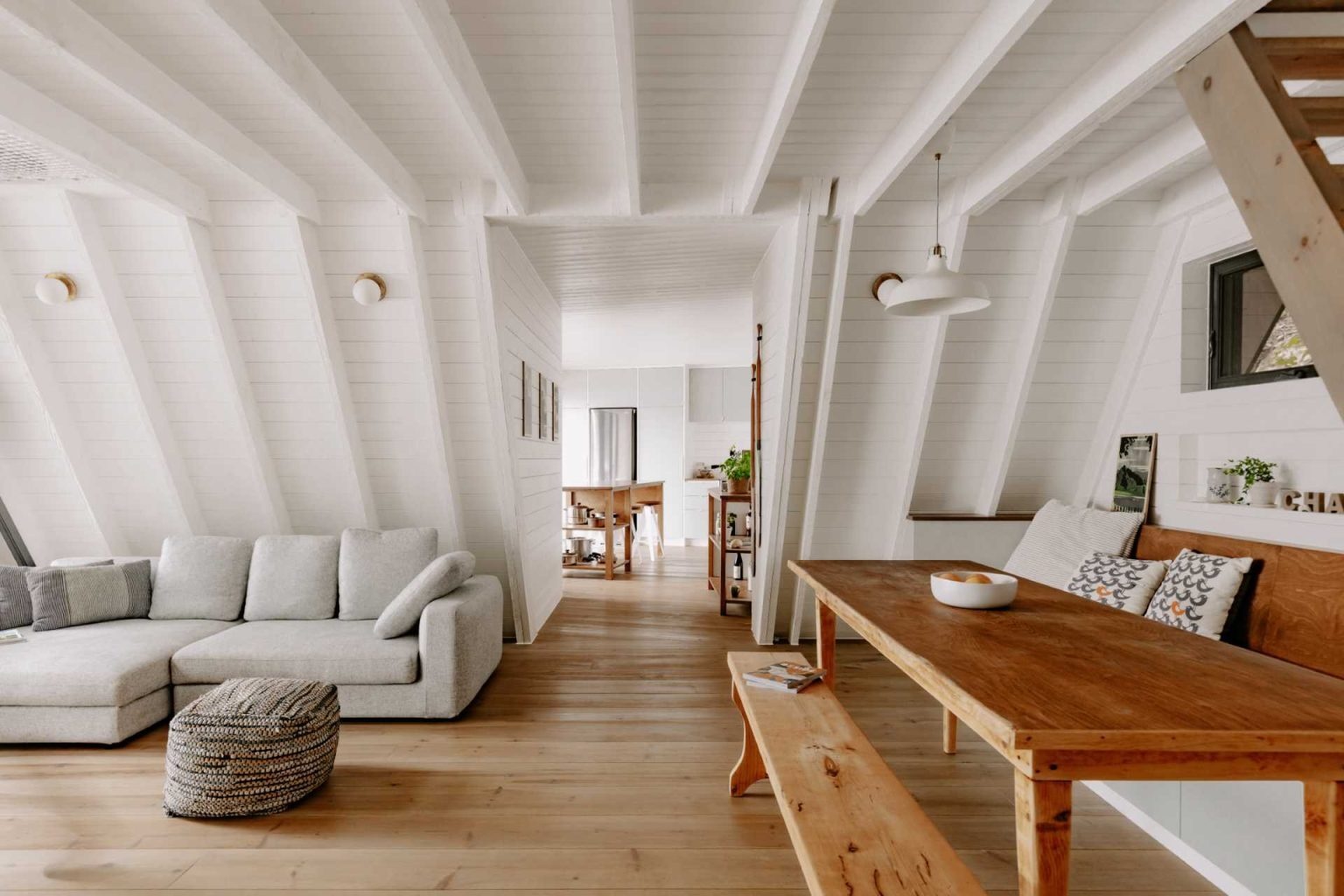 Vaulted ceilings, panoramic lake views and built-in seating make this open living and dining space both beautiful and practical for everyday use.