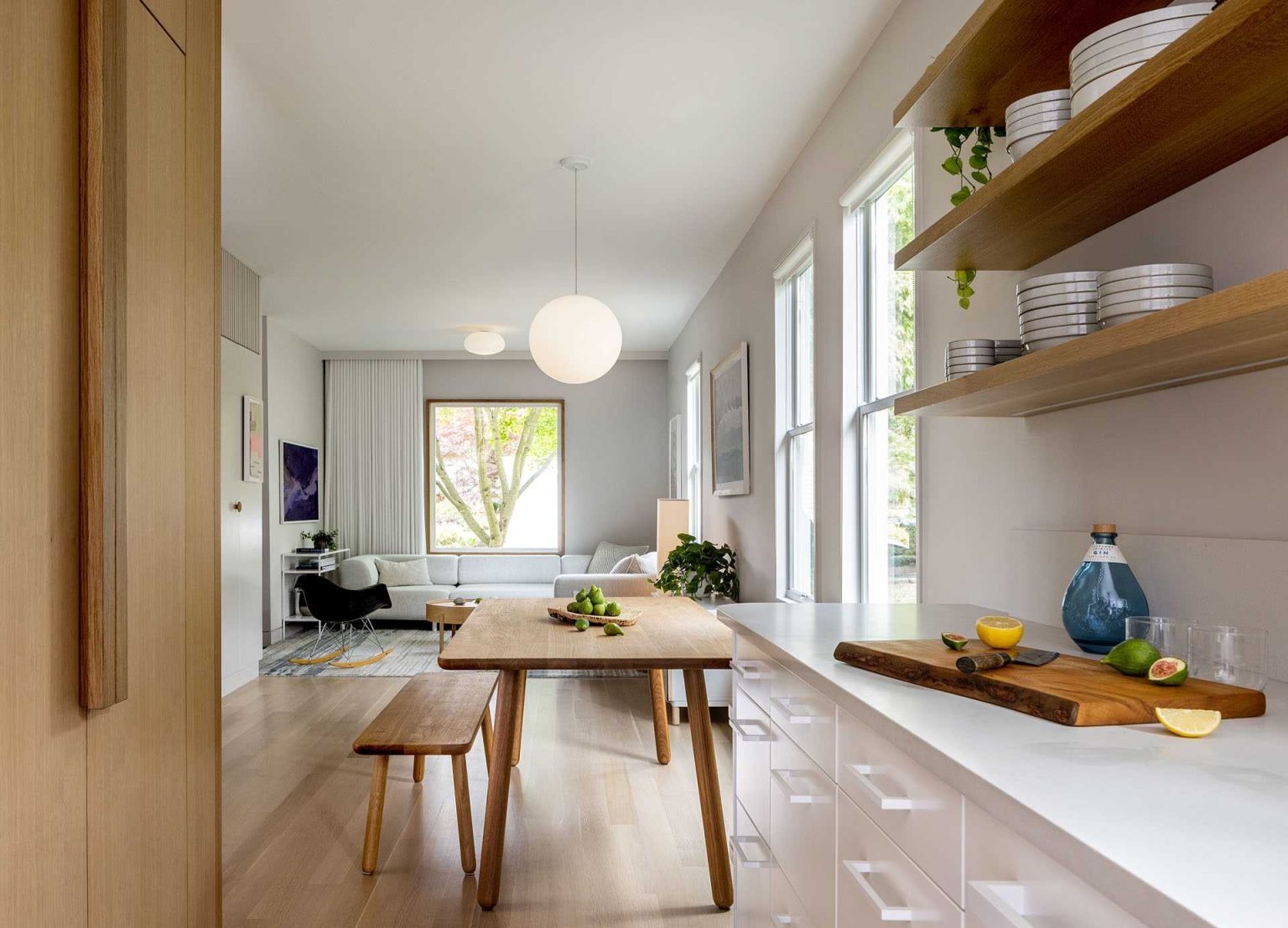 This open-plan layout combines living, dining, and a compact home workspace, showing how small homes can deliver flexible everyday living.