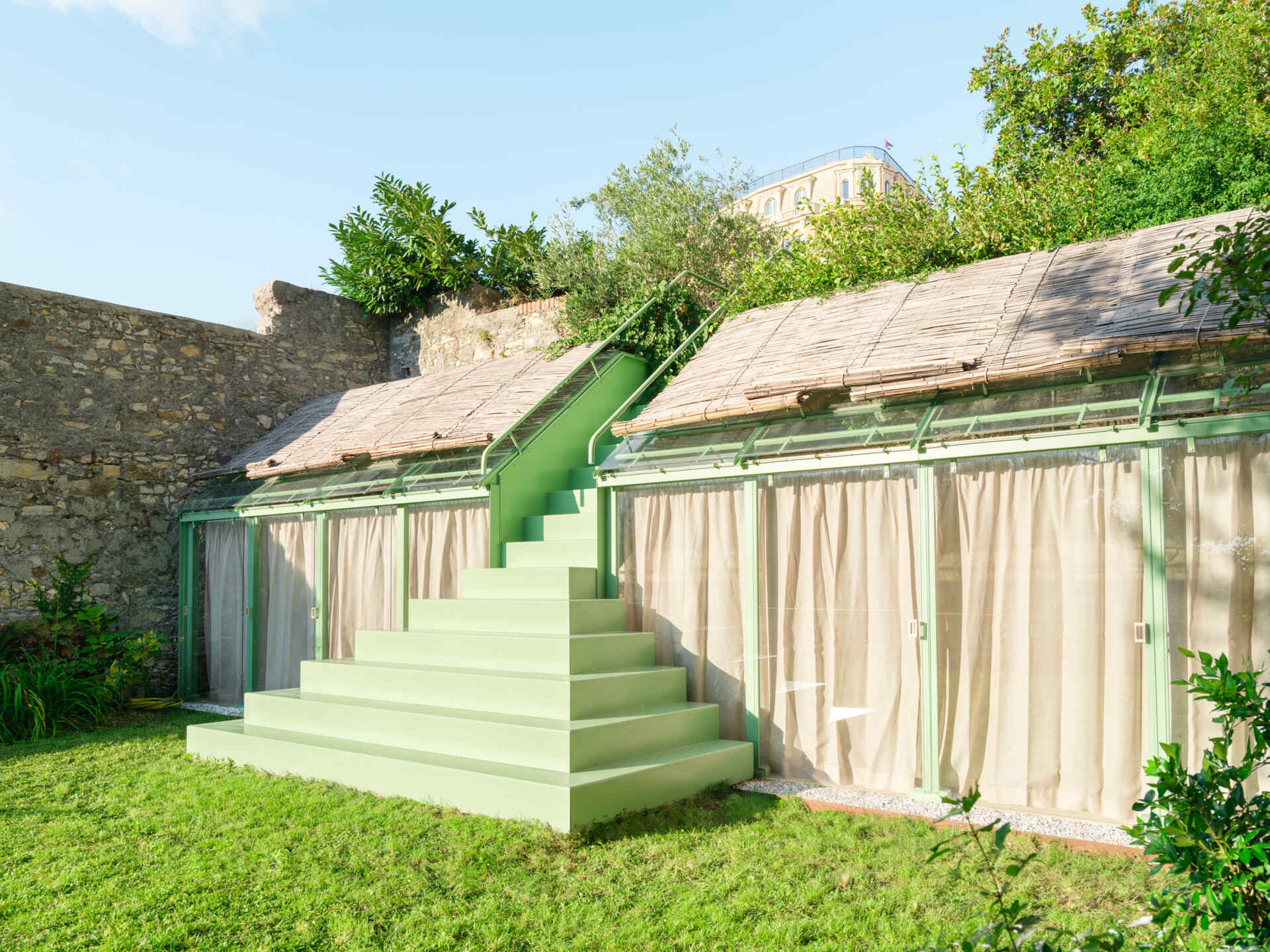 This sculptural powder-coated steel staircase transforms a simple garden path into an architectural feature with beautiful changing views.