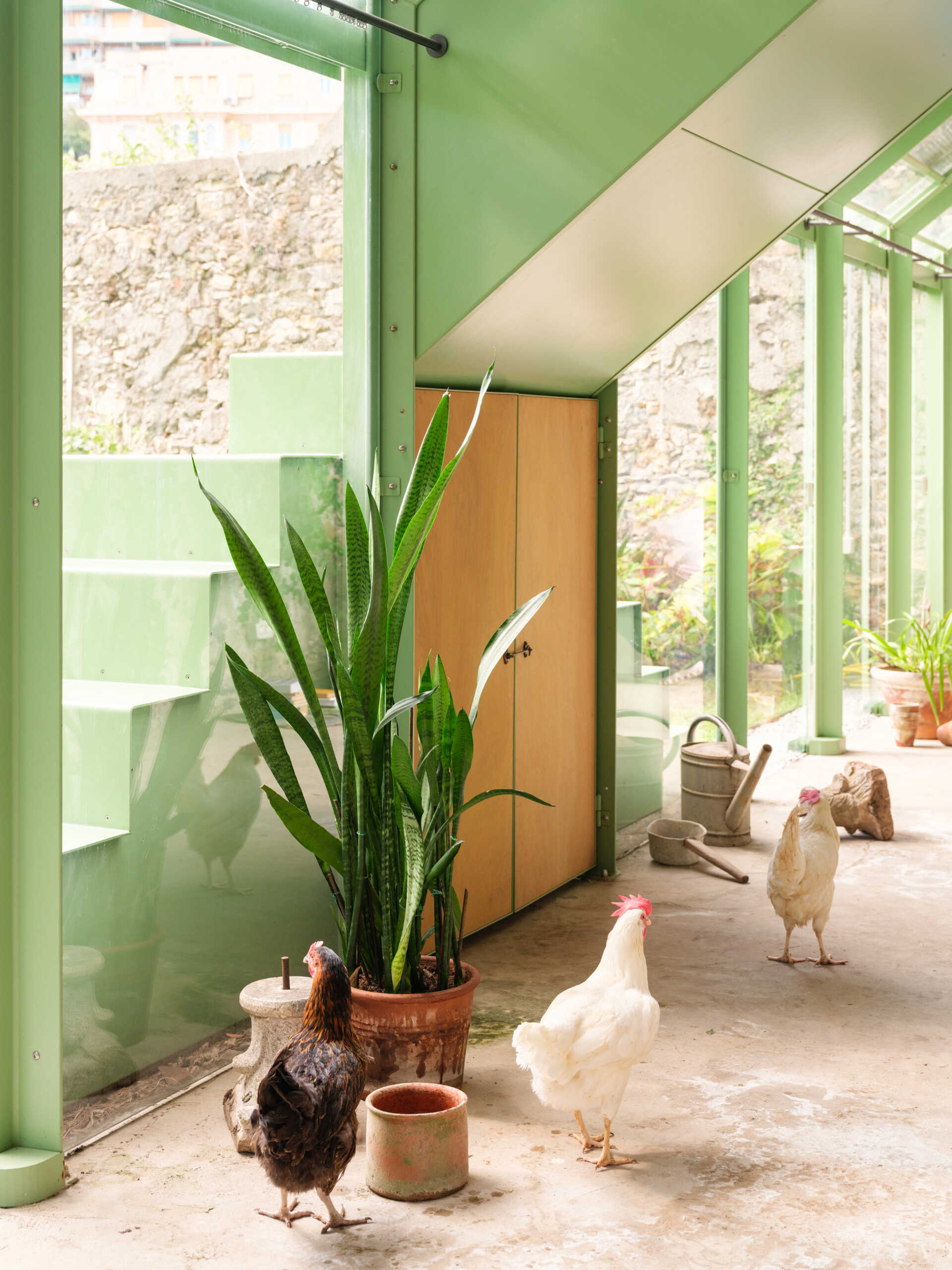 Historic masonry, slim steel framing, and glass come together in this elegant garden project that blends contemporary architecture with an existing landscape.