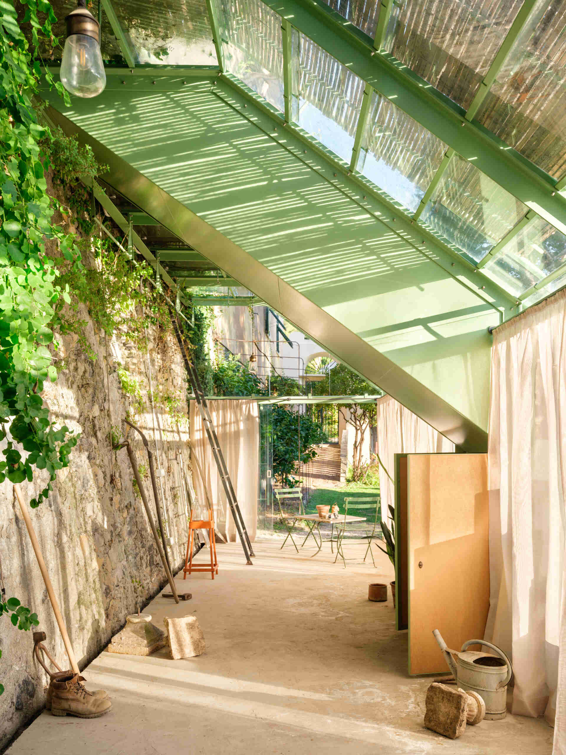 Historic masonry, slim steel framing, and glass come together in this elegant garden project that blends contemporary architecture with an existing landscape.