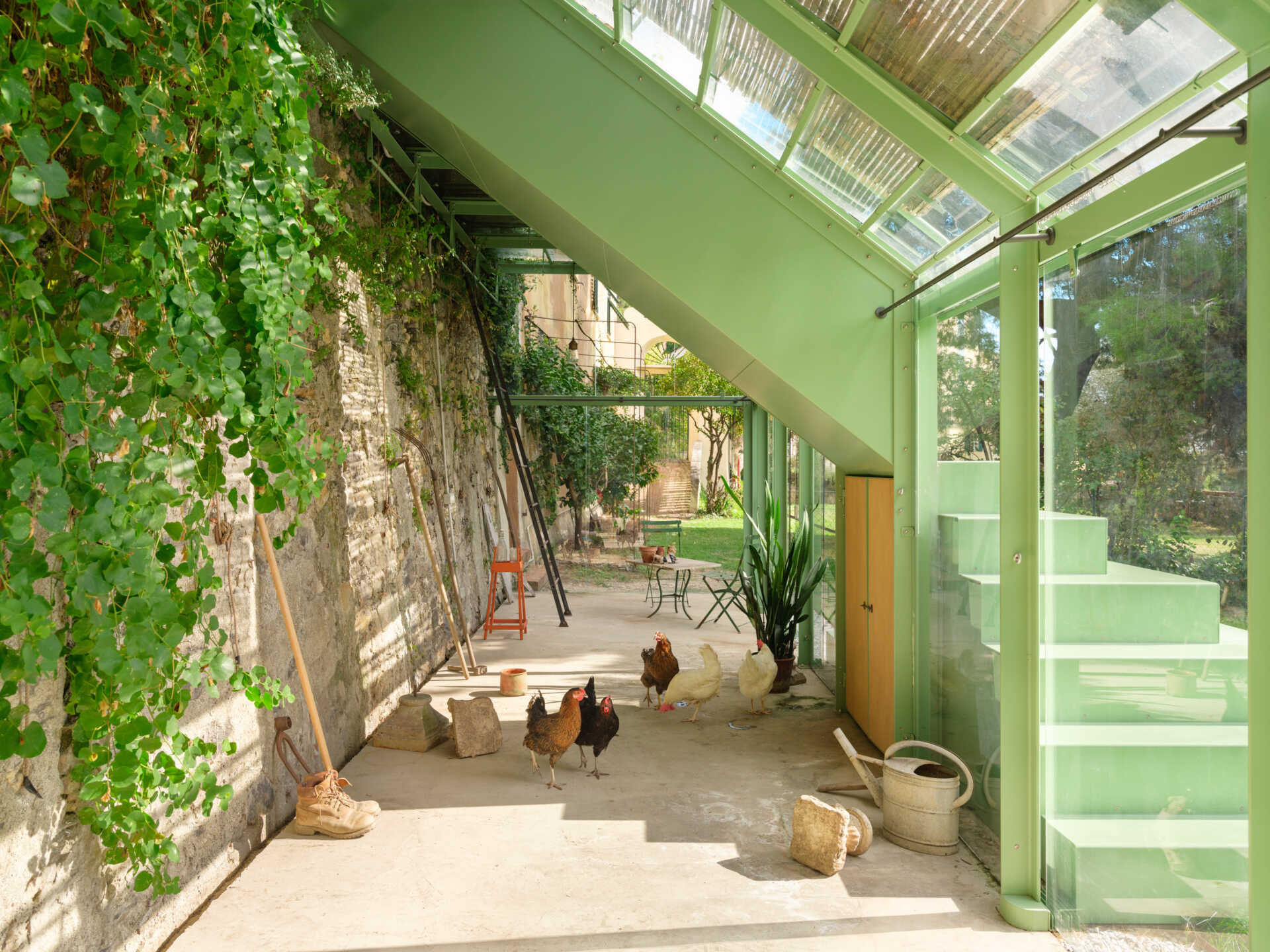 Historic masonry, slim steel framing, and glass come together in this elegant garden project that blends contemporary architecture with an existing landscape.
