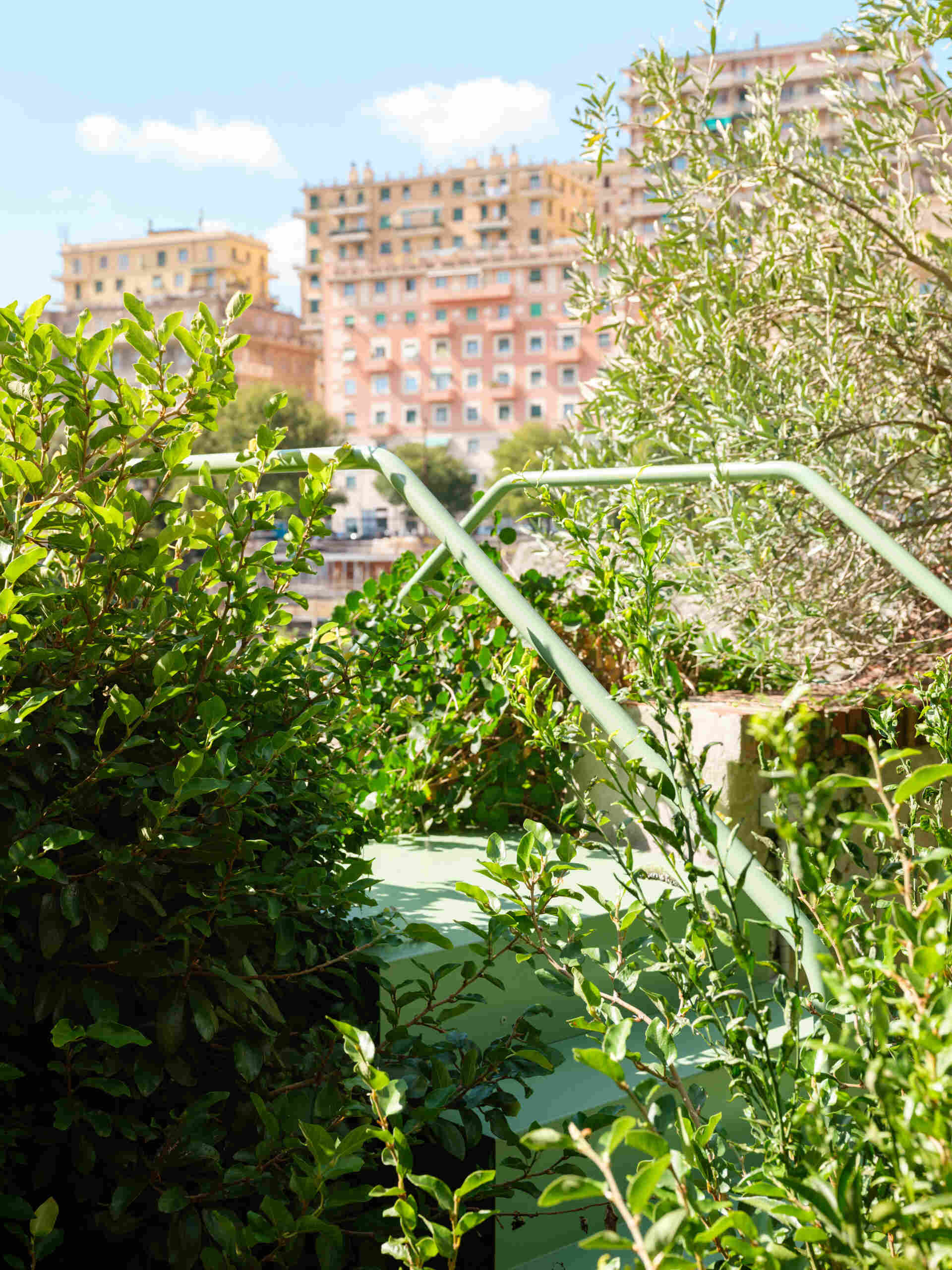 This sculptural powder-coated steel staircase transforms a simple garden path into an architectural feature with beautiful changing views.