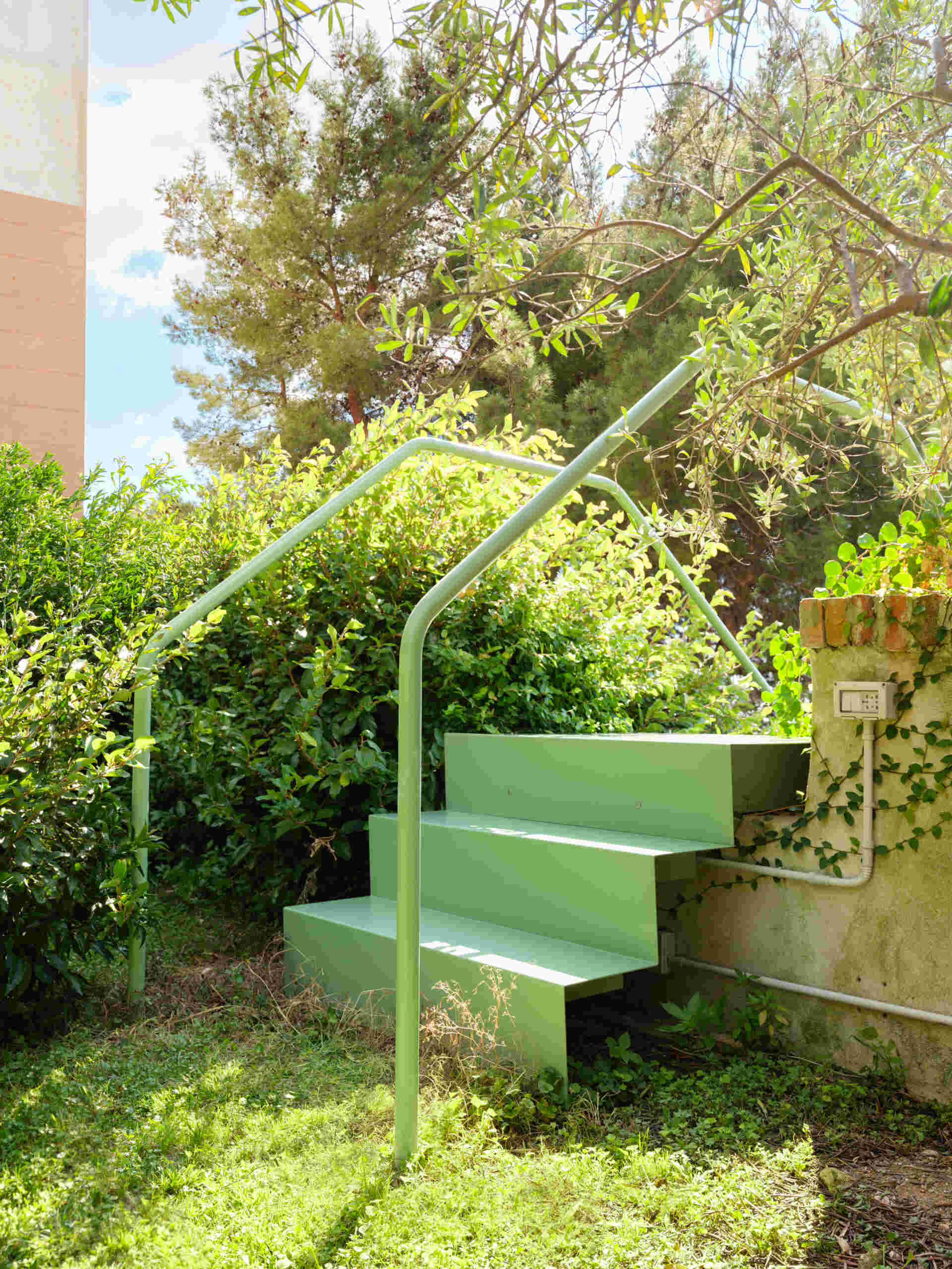 This sculptural powder-coated steel staircase transforms a simple garden path into an architectural feature with beautiful changing views.