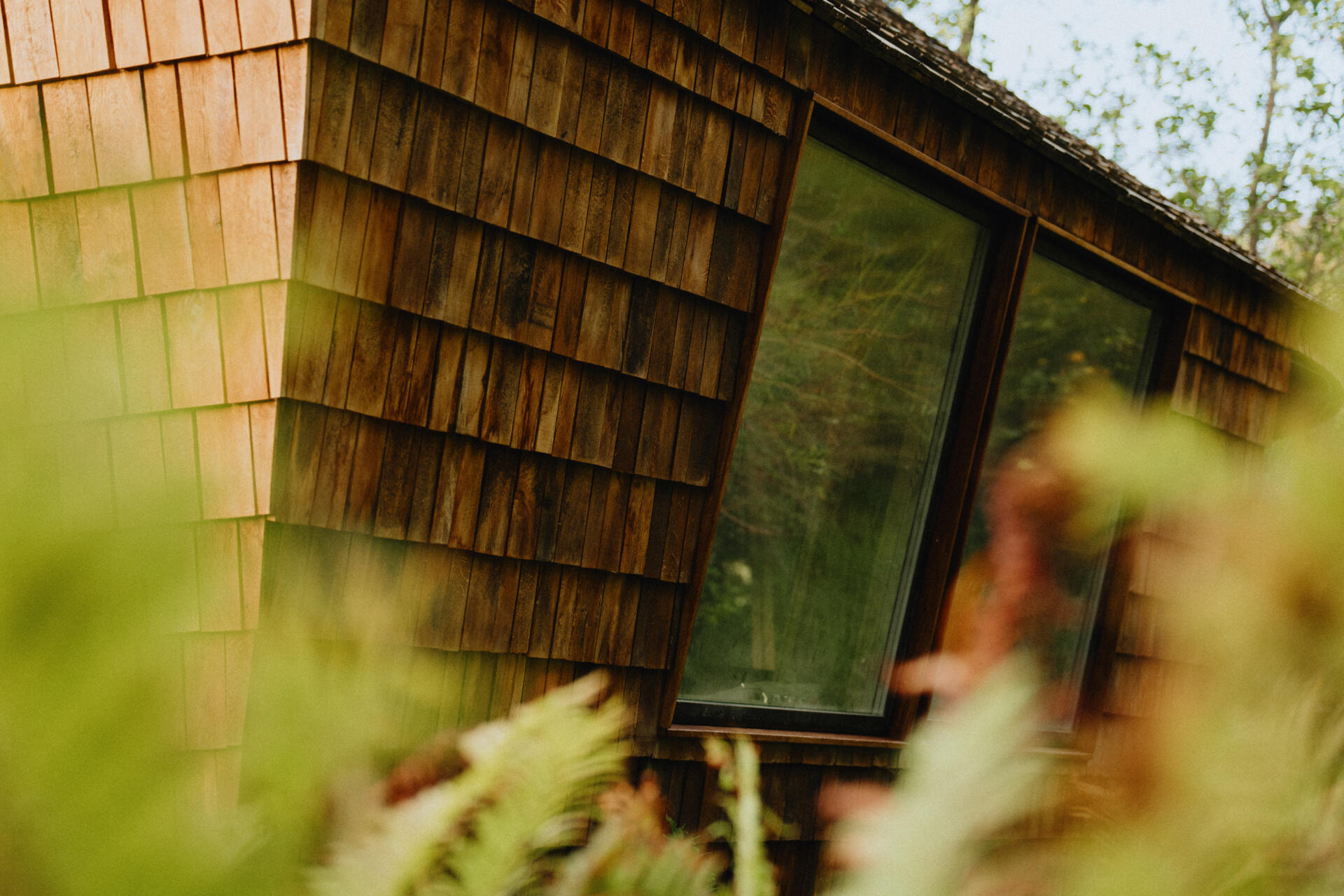 Natural timber, digital fabrication, and a low-carbon approach shape a garden house's warm exterior and efficient construction.