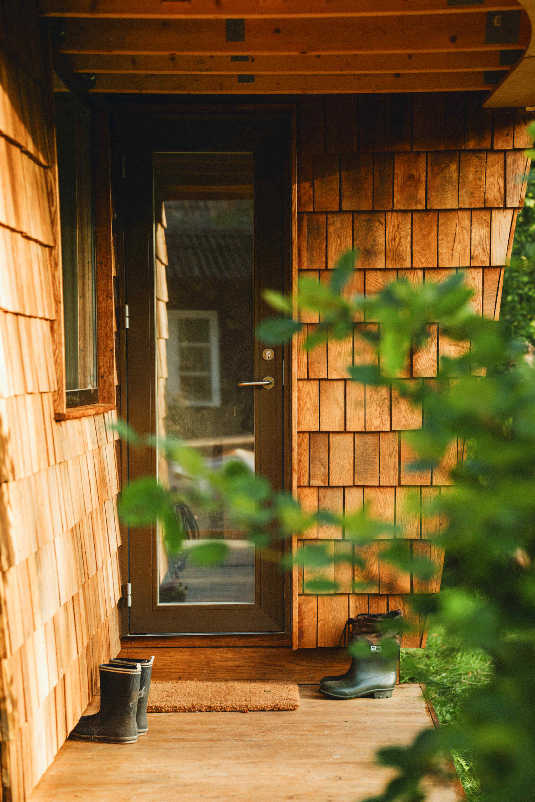 Natural timber, digital fabrication, and a low-carbon approach shape a garden house's warm exterior and efficient construction.