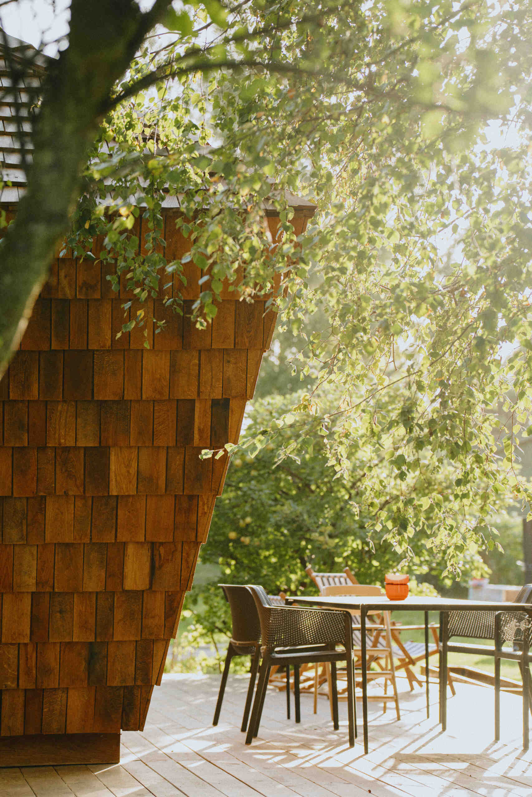 Natural timber, digital fabrication, and a low-carbon approach shape a garden house's warm exterior and efficient construction.
